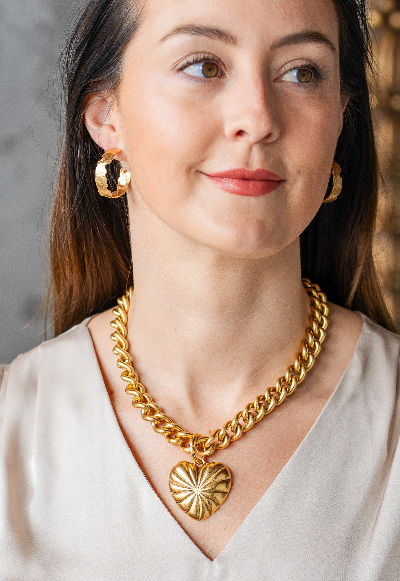 Chunky gold necklace with a large ridged heart charm and “grateful” tag, worn three ways