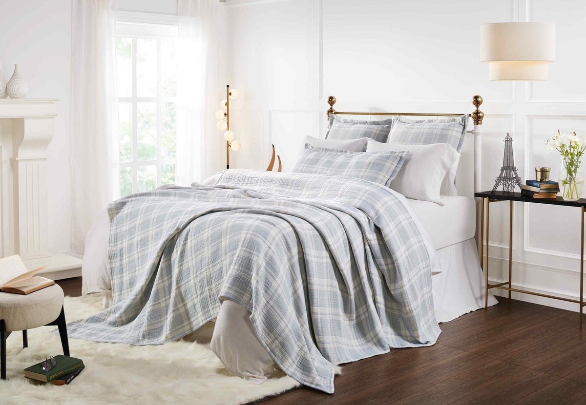 BT-117-11096_5|Light blue and white plaid patterned cotton quilt blanket draped over a bed, creating a cozy and stylish bedroom aesthetic.