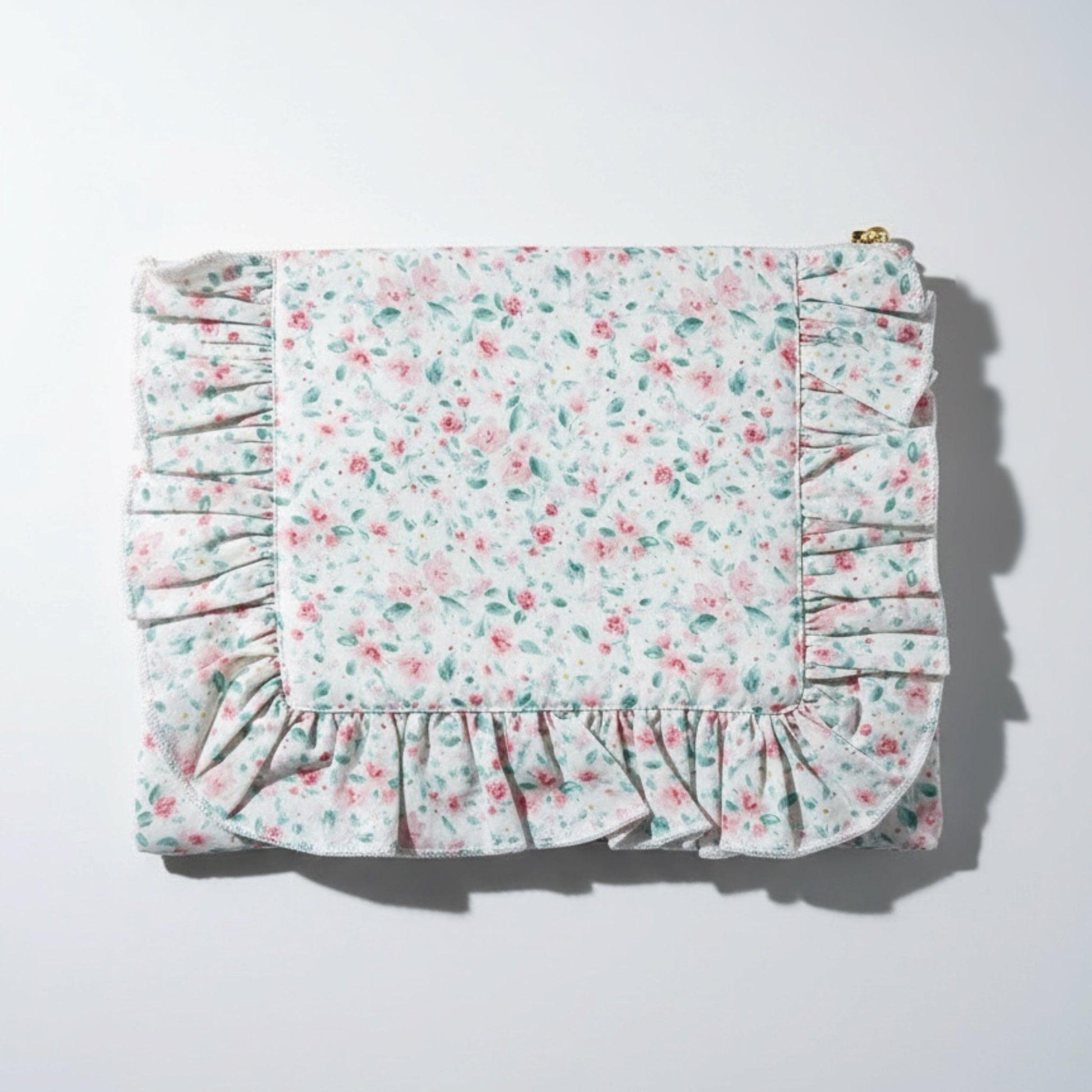 Floral patterned fabric with ruffled edges on a white background