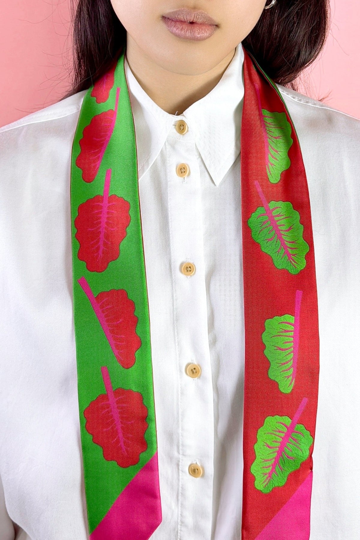 A twilly bow ribbon silk scarf with red chard and neon pink details. Double sided