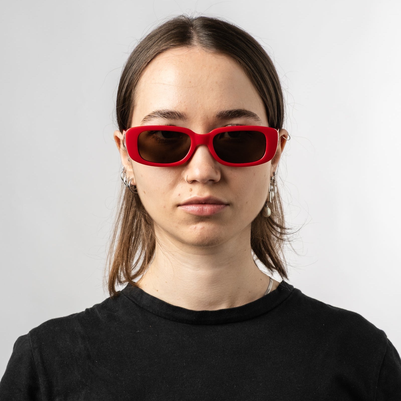Female wearing Sad Eyewear Bouquet rectangle sunglasses in cherry red with uv protection lenses