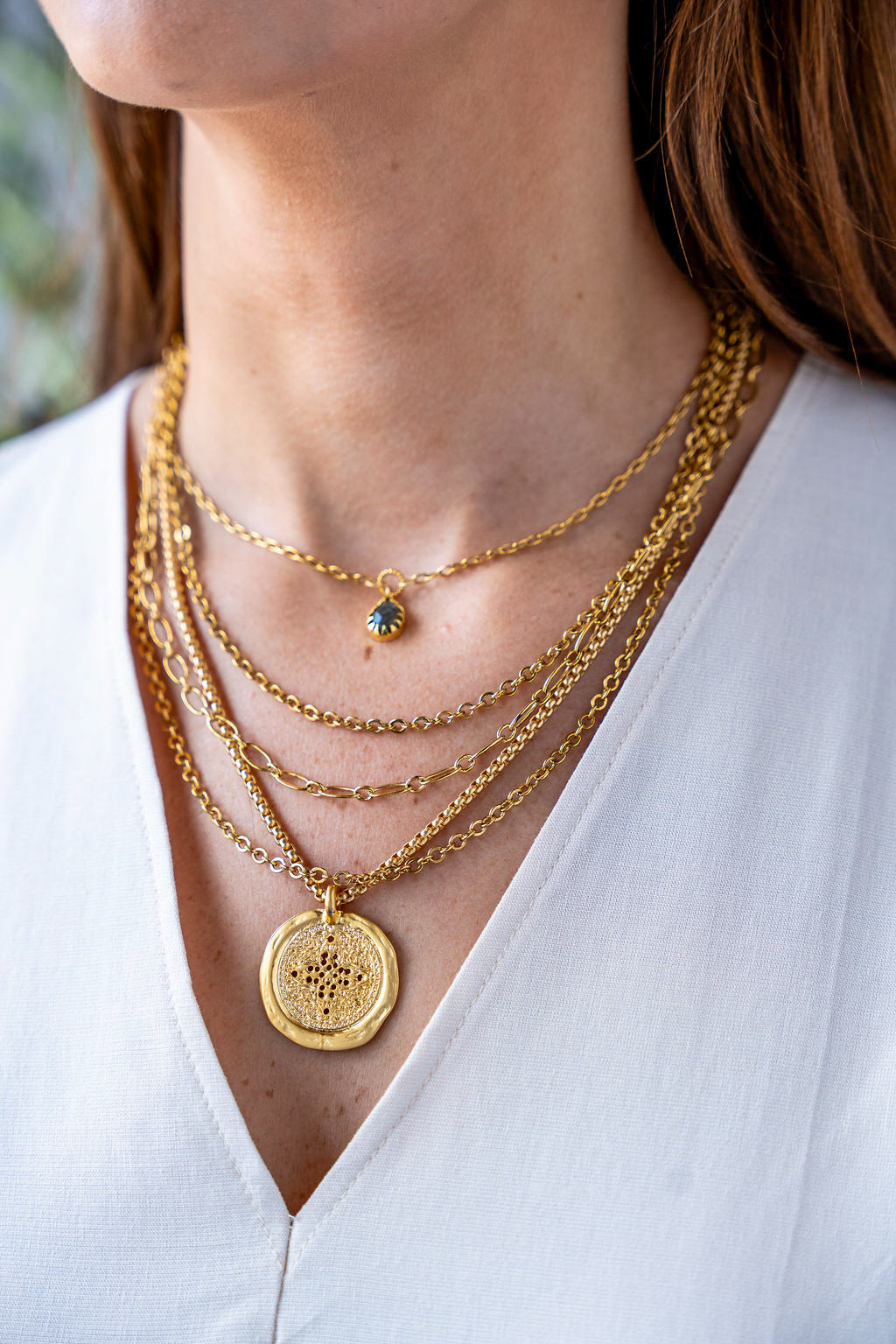 Gold chain necklace with a faceted teardrop labradorite pendant in a prong setting