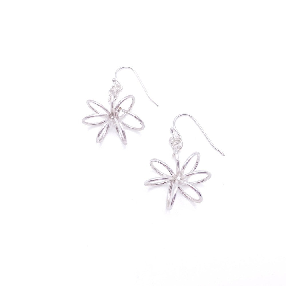 Silver flower Artisan earrings modeled