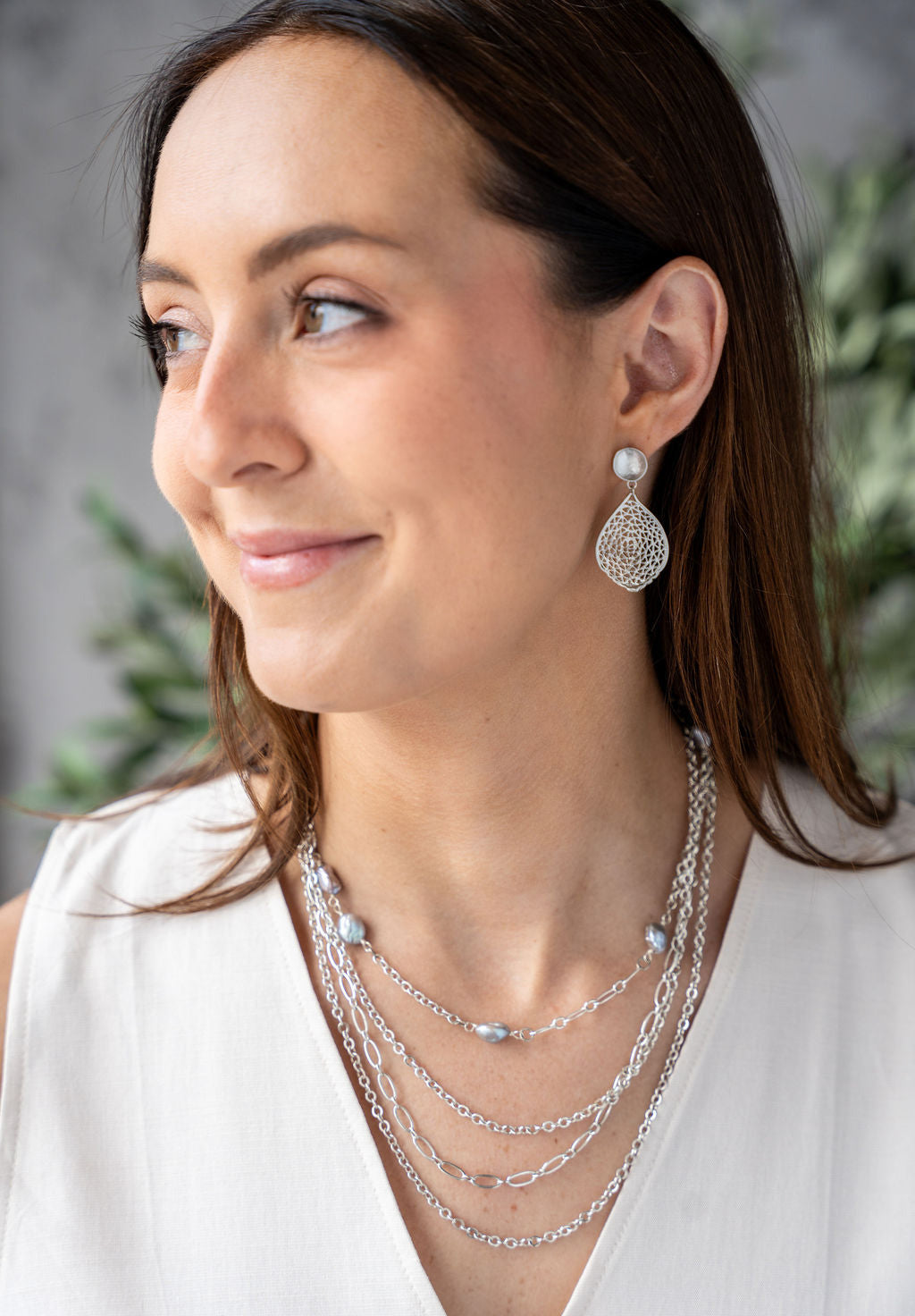 Silver-colored three-strand necklace with delicate mixed chain styles and adjustable clasp