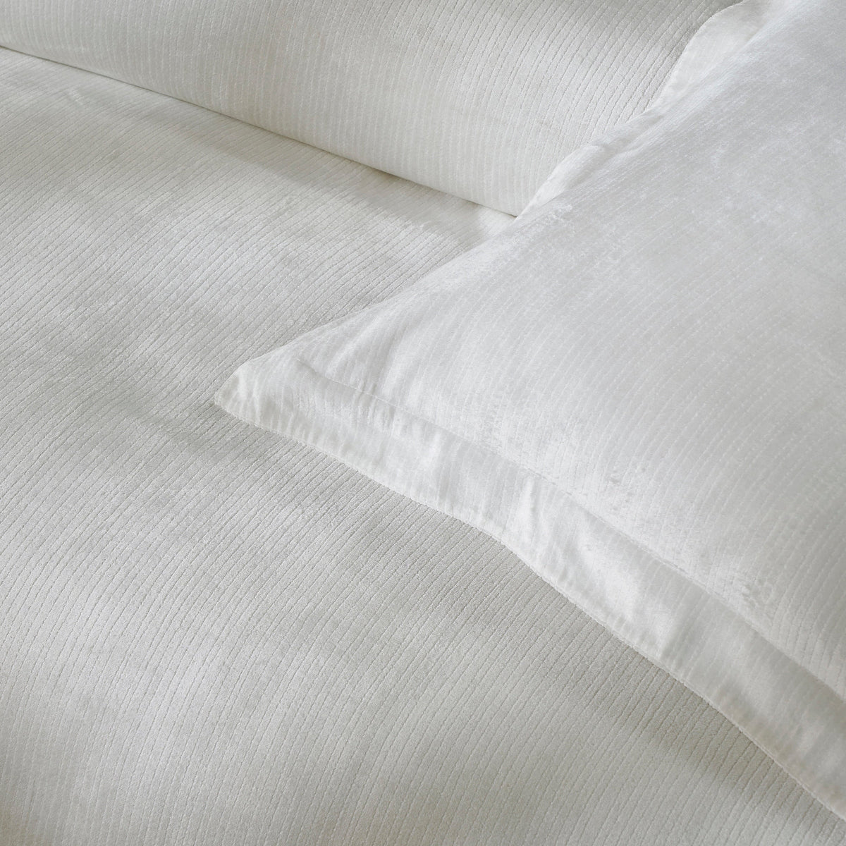 DT-052-10692_6|Elegant white textured duvet cover fabric, softly folded to reveal its subtle striped pattern and luxurious feel.