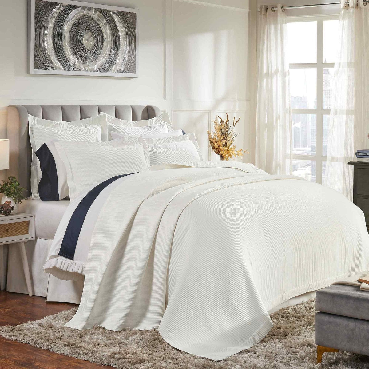 CL-192-11096_2|Elegant white striped coverlet gracefully draped across a bed, adding sophisticated texture to a stylish bedroom.