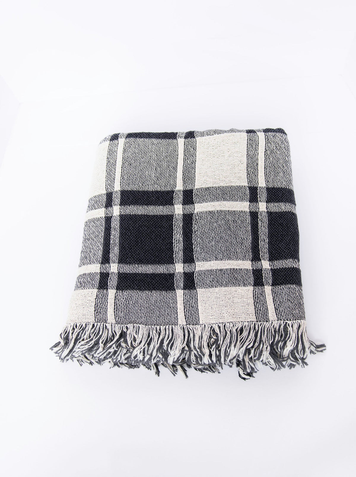 Overhead view of folded Ellis neutral plaid woven throw with fringe