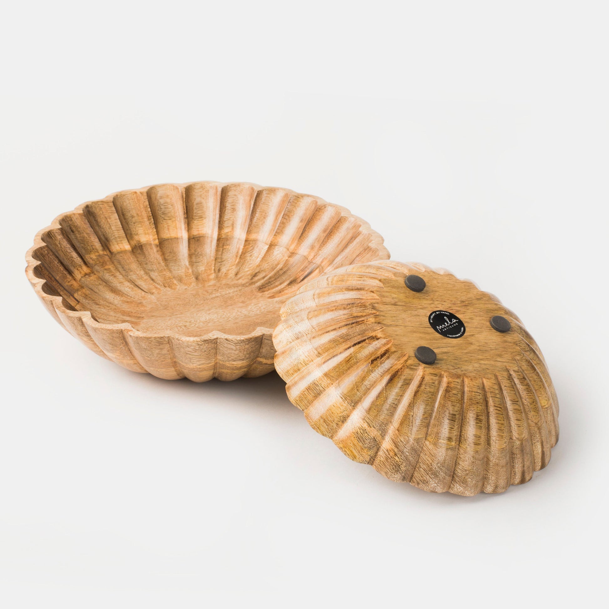 Set of two hand-carved scalloped mango wood bowls nested together