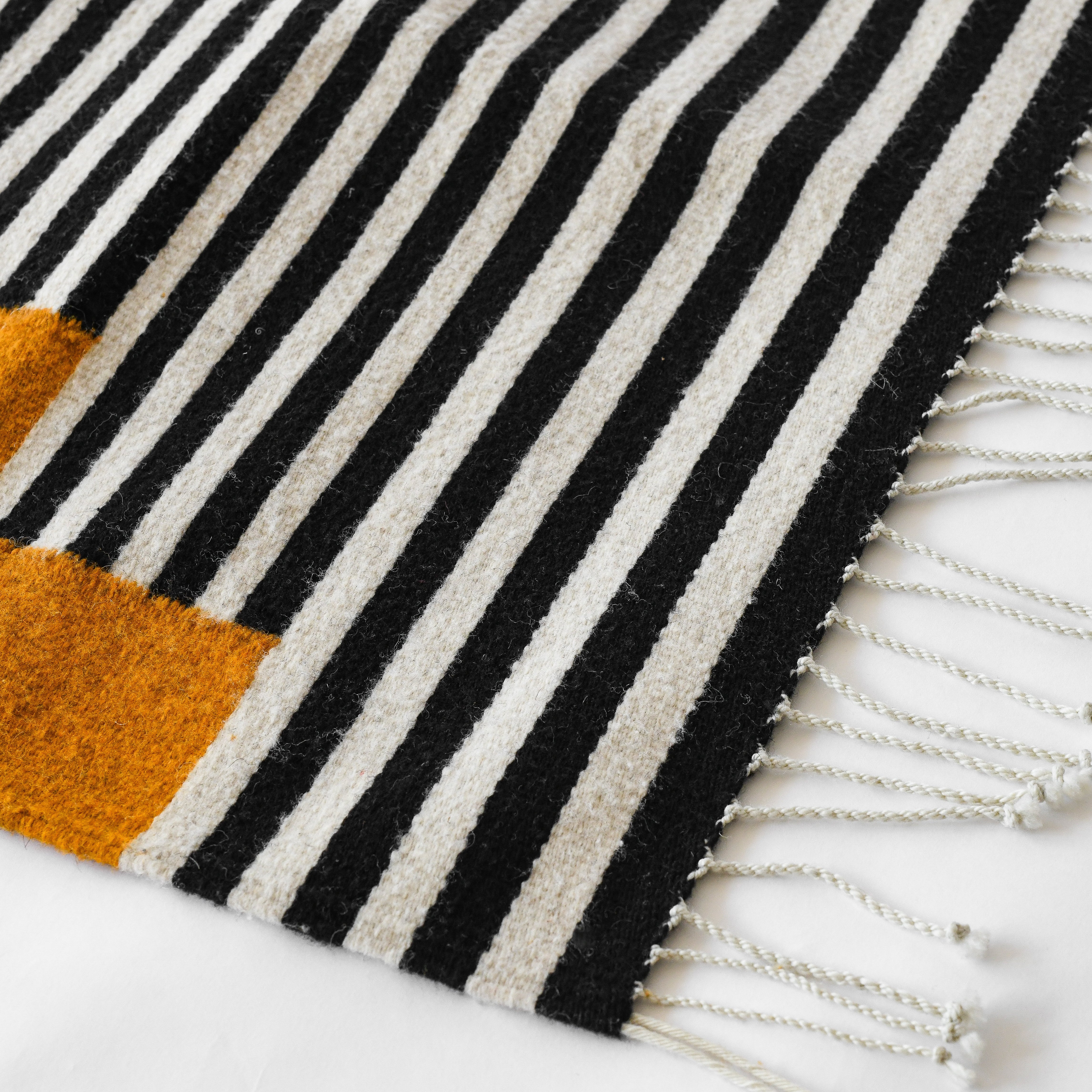 LOOM Imports handwoven ethical flat weave wool rugs. B Corp certified, women owned, fair trade, natural sustainable materials. 