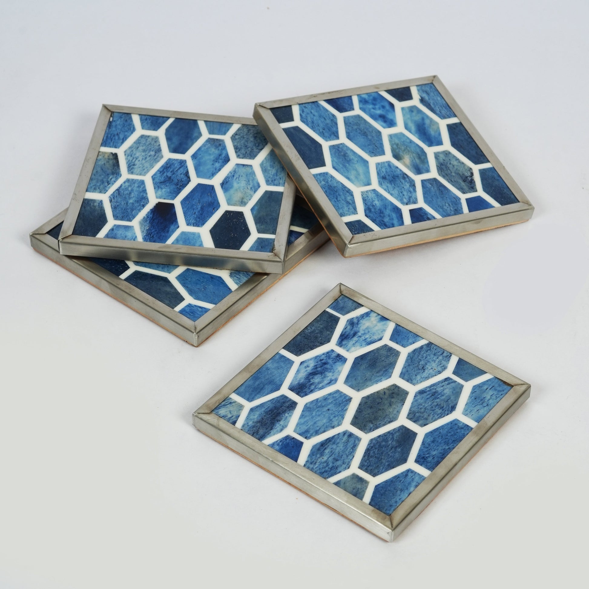 Indigo blue decorative coasters with white ethically sourced bone inlay in a geometric pattern for home tabletop protection.