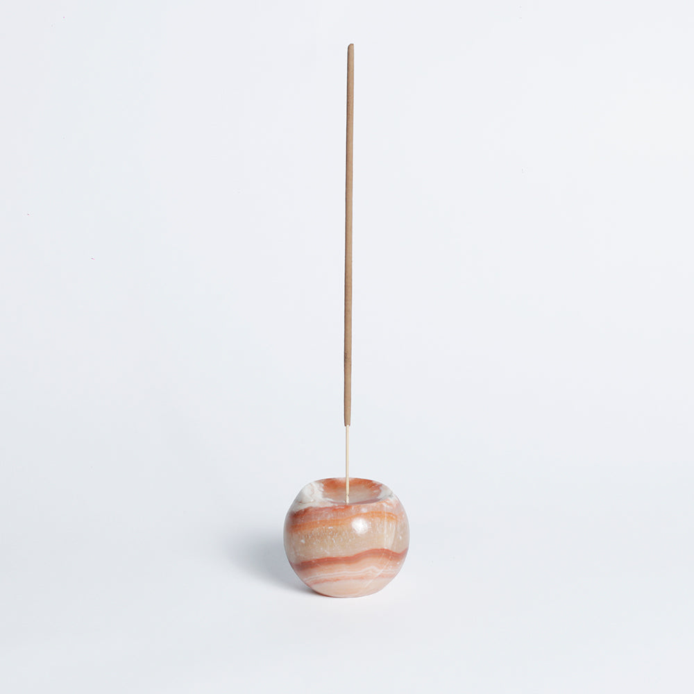 Cream onyx gemstone sphere incense holder displaying its warm, natural tones on a white background.