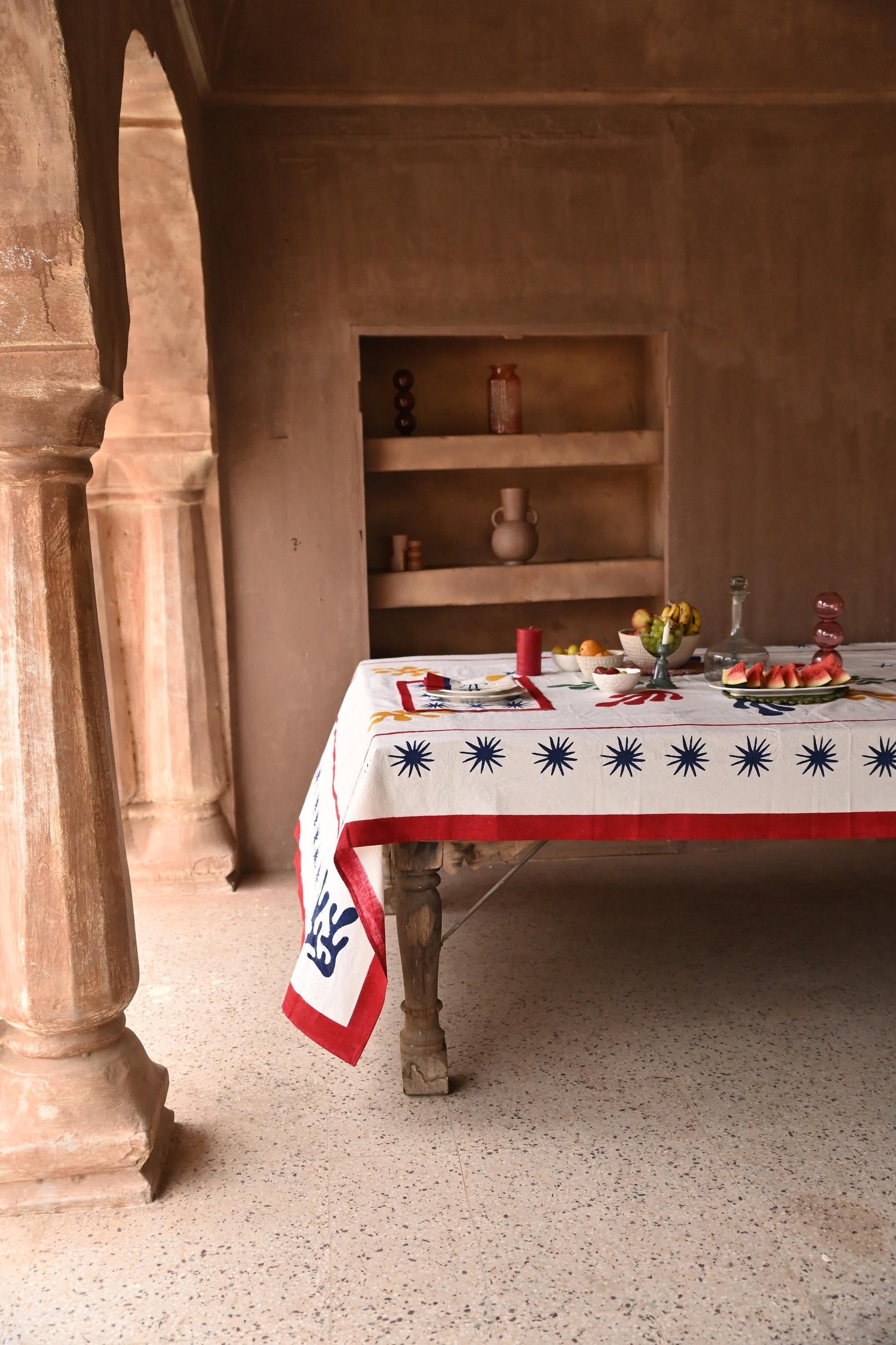 Inner Child Celestial Matisse Blockprint tablecloth on wooden table with fruit display