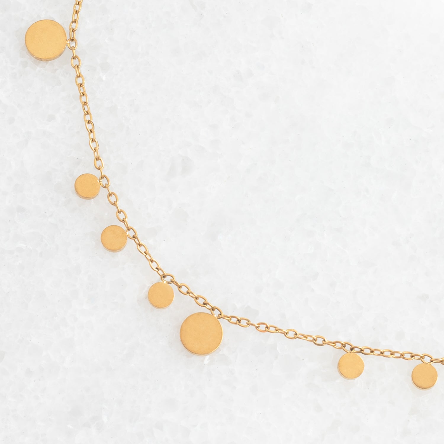 Photo of gold necklace, confetti shaped necklace, necklace for layering, golden circles, jewelry website, fair trade