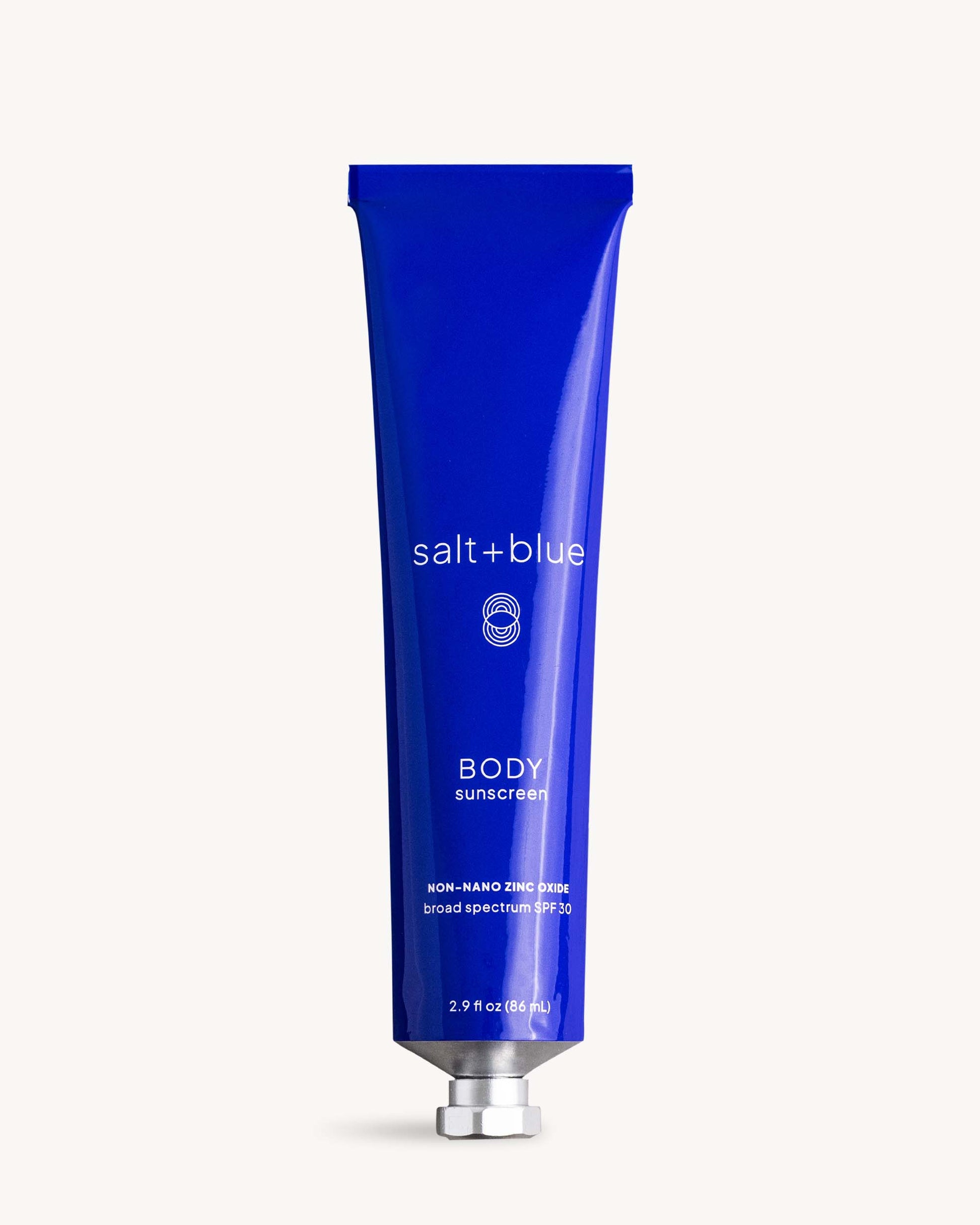 Blue tube of salt+blue body sunscreen on a white background