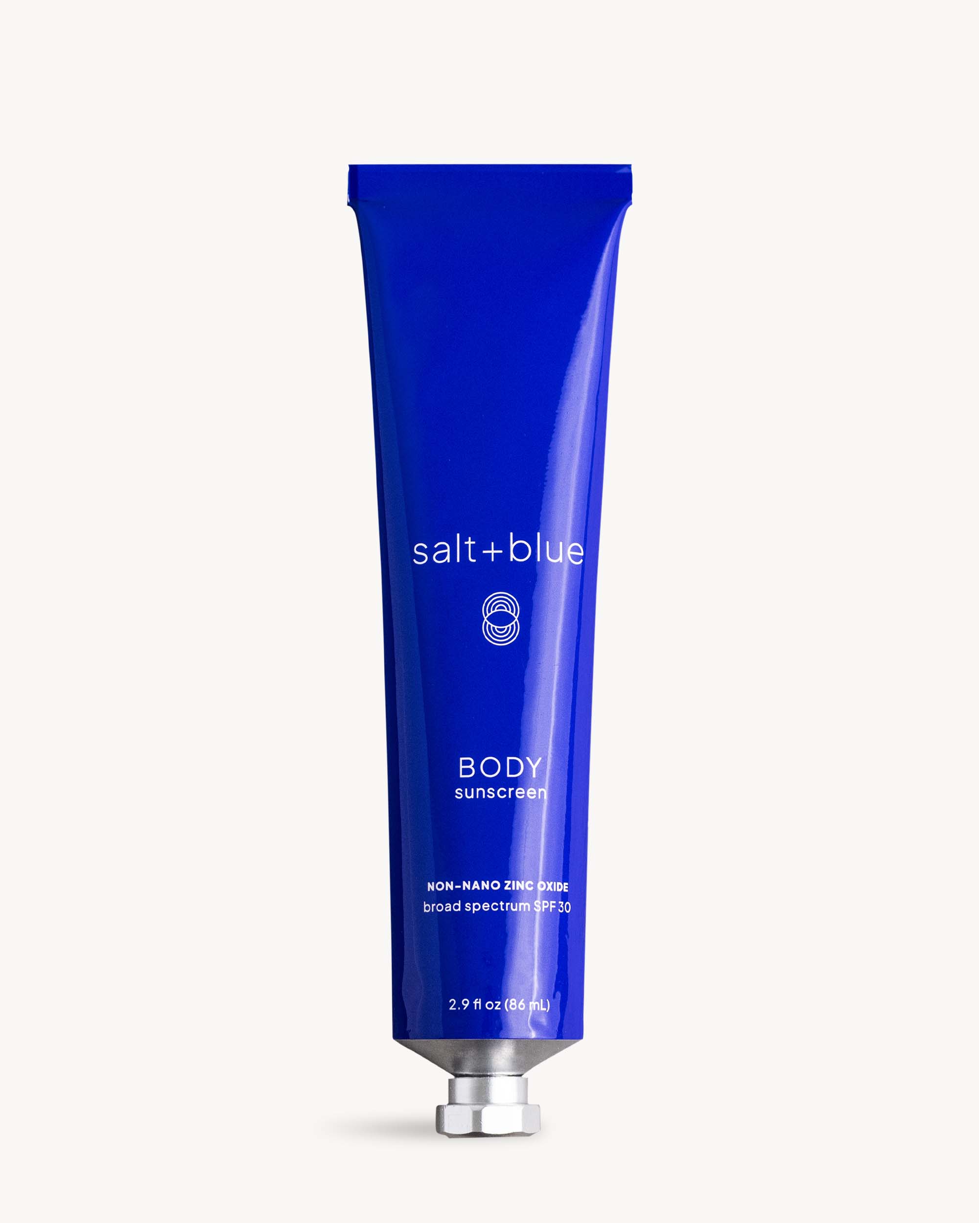 Blue tube of salt+blue body sunscreen on a white background