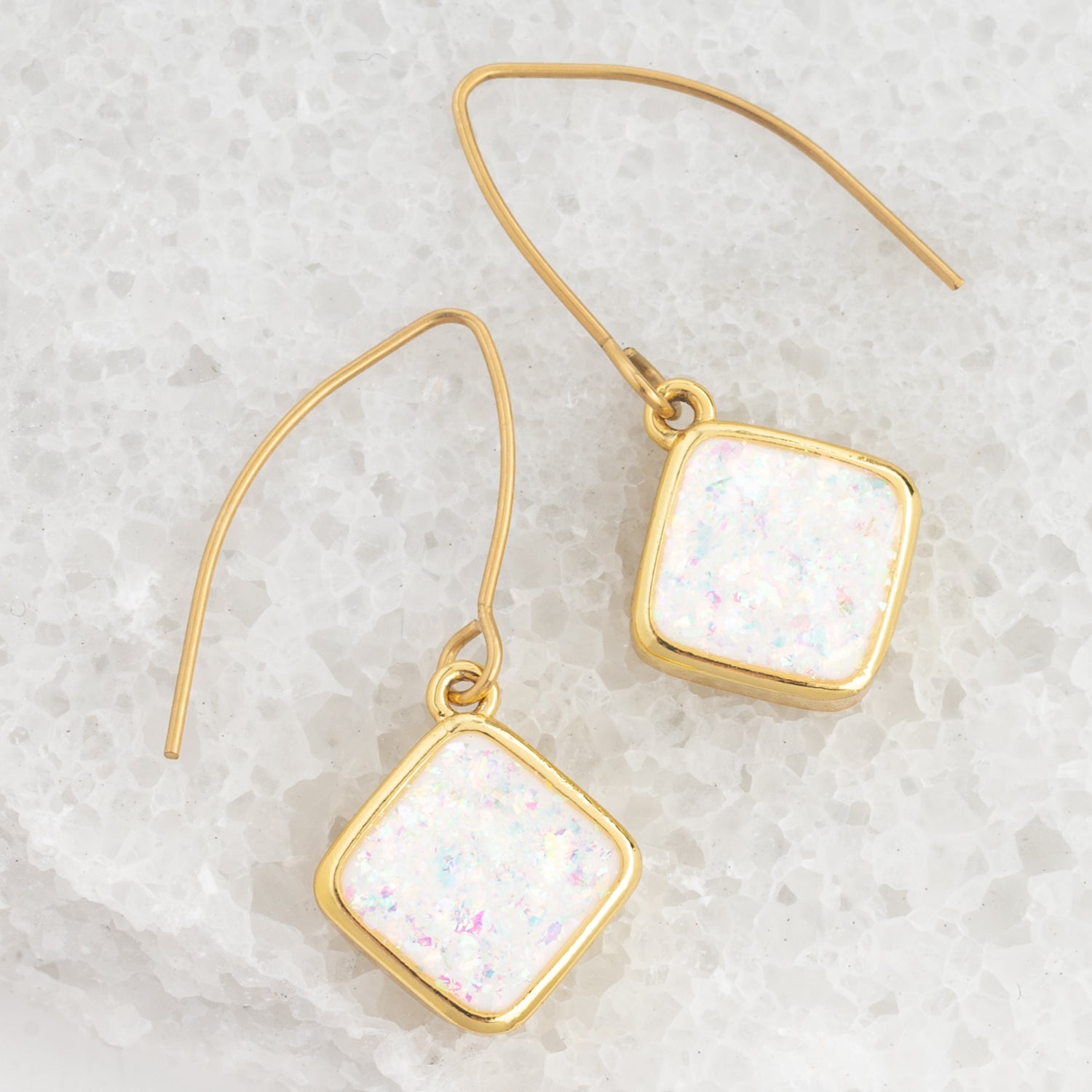 Model photo of gold dangling earring, fashion opal earring, sustainable fair trade jewelry company