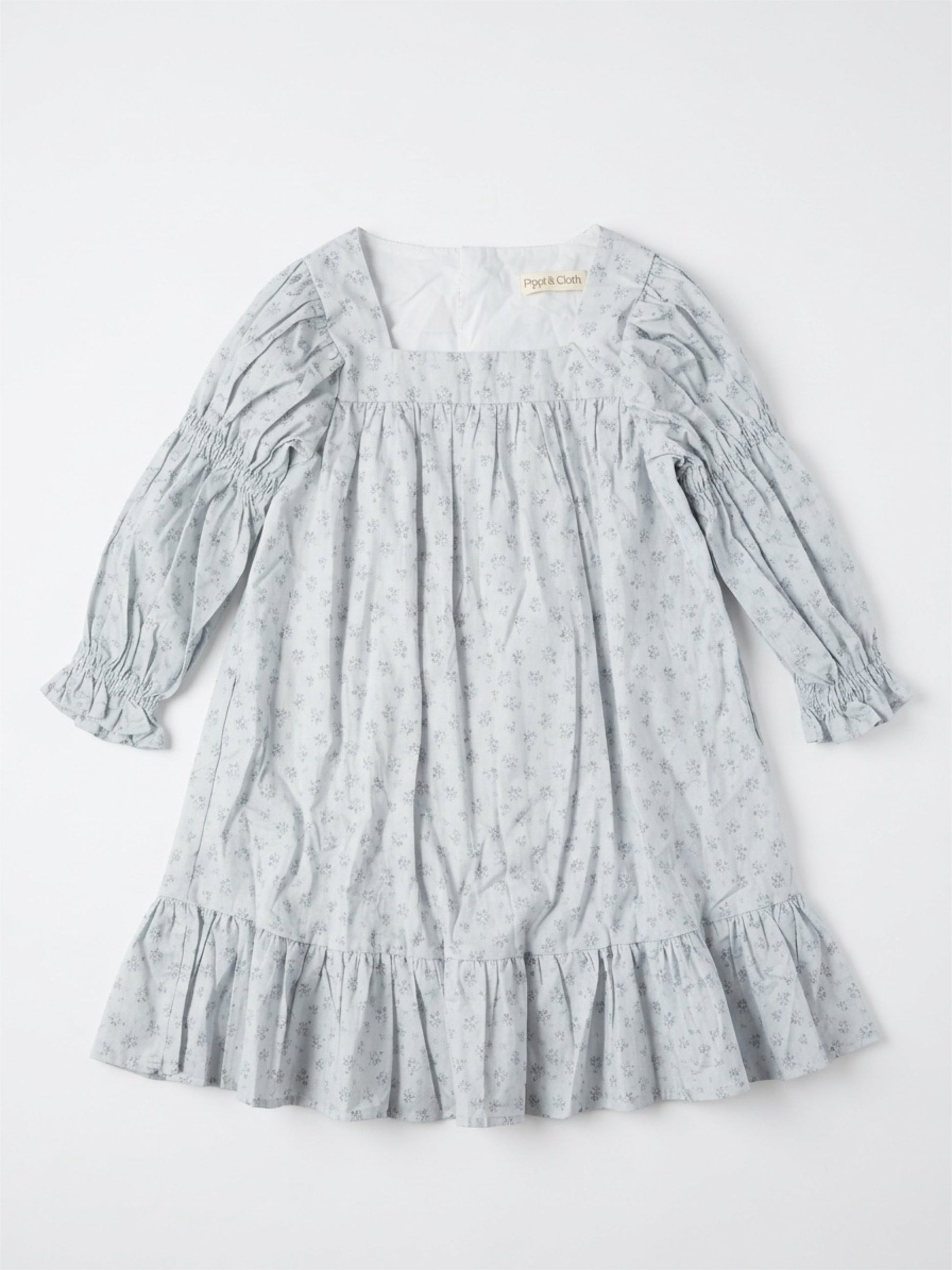 Light blue dress with floral pattern on a white background