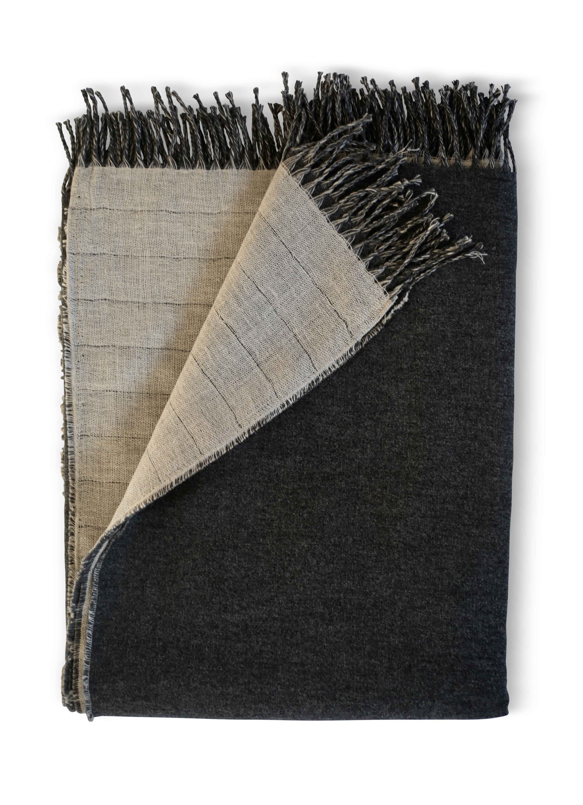 A lavish, oversized throw blanket by Evangeline Linens. Crafted with exquisite linen and merino wool, featuring fringes and a reversible design. Pure luxury.