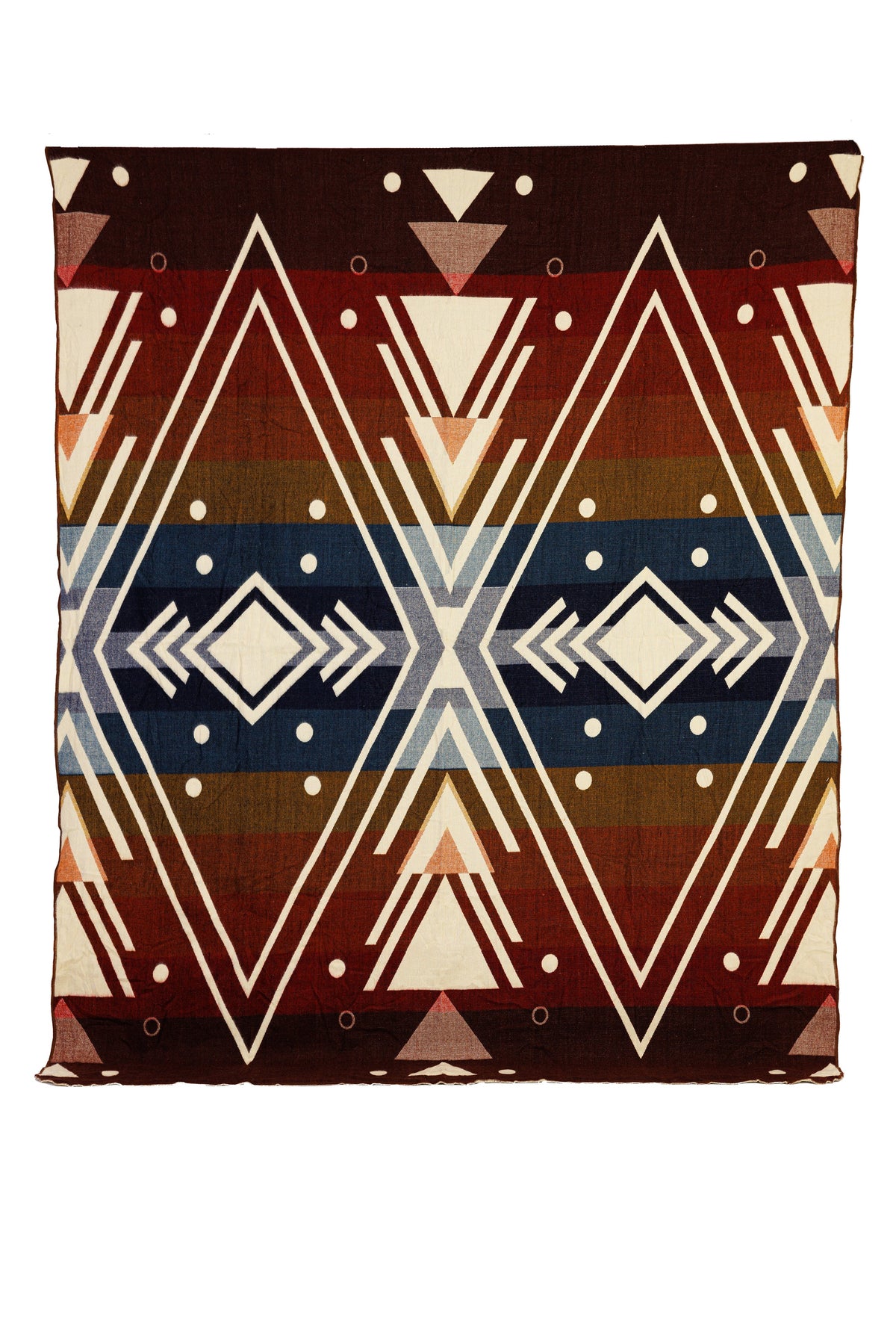 A woven alpaca blanket with a geometric chevron pattern in red, blue, peach, and brown, displaying both sides of the blanket with a reversible design.
