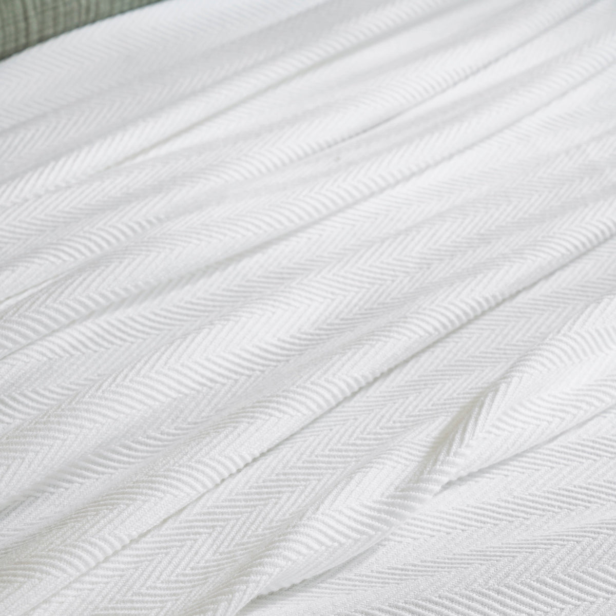 BL-865-9496_6|White herringbone textured blanket, neatly folded, ideal for cozy bedding or a stylish sofa throw. Soft and luxurious.