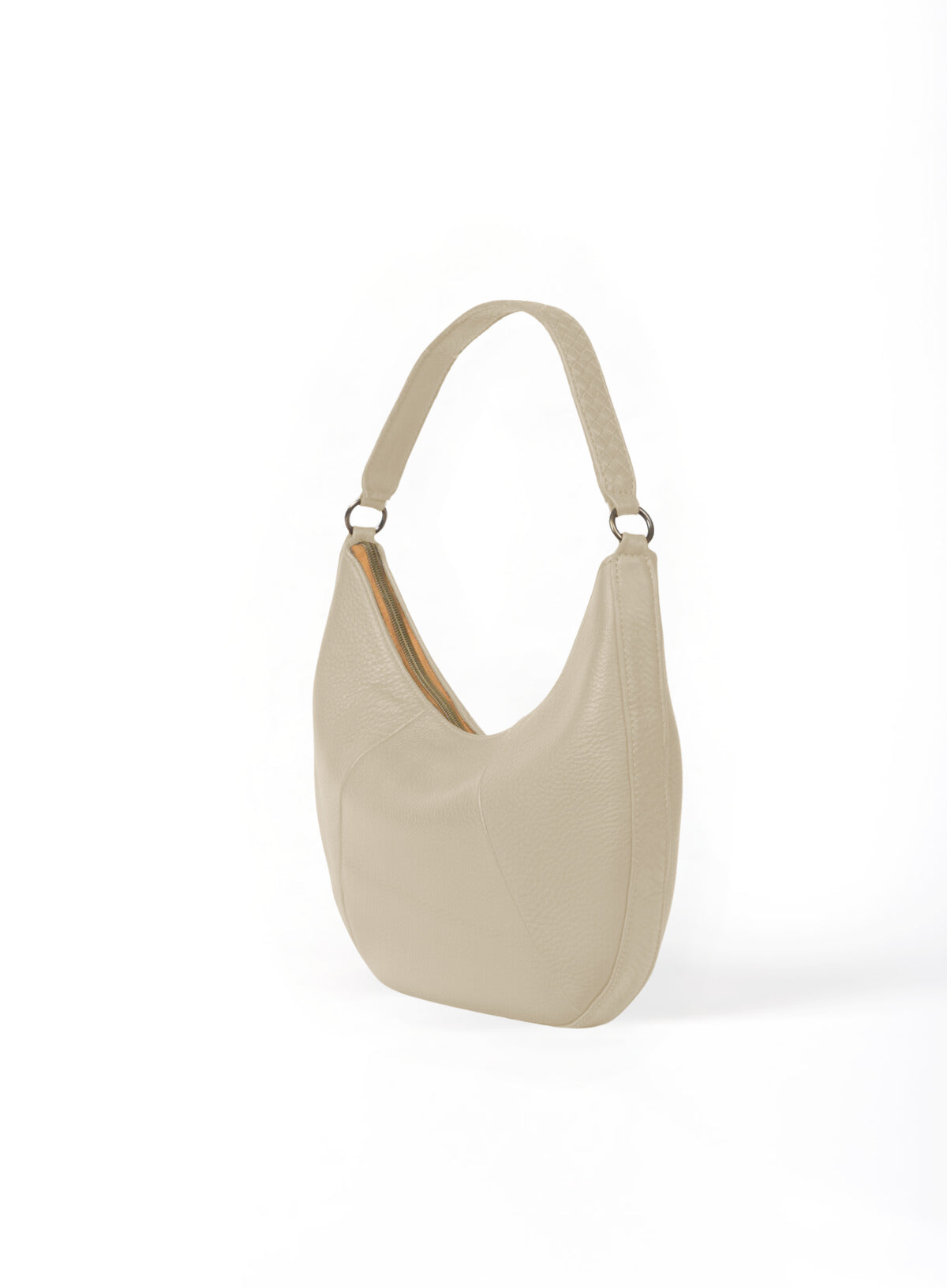 baguette bag from spring collection in bone color held by haitian artisan in factory.