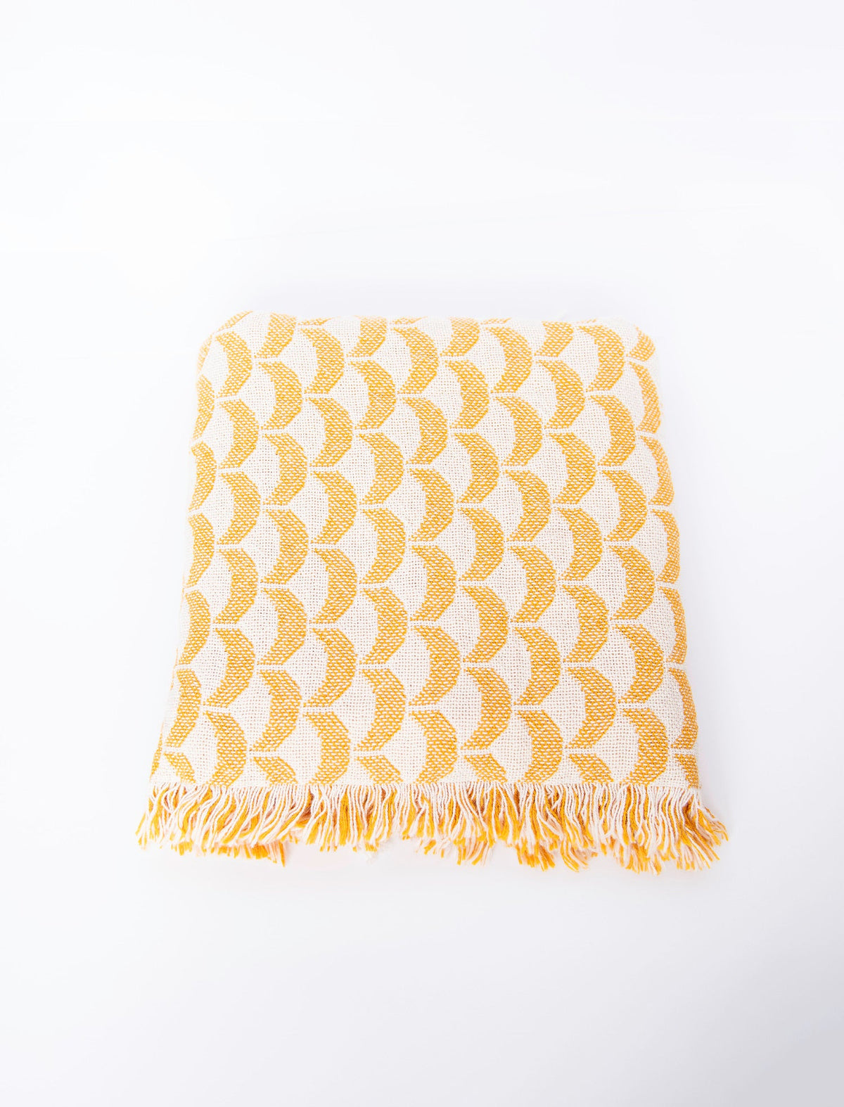 Front view of folded yellow and cream scallop woven cotton throw on a white background