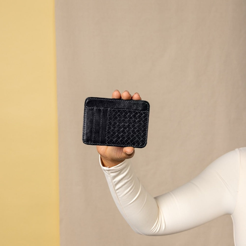 Black leather woven wallet held in a hand with 'DEUX MARS' branding