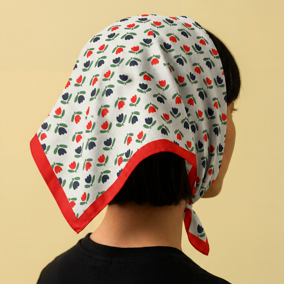 red and black tulip pattern bandana on white background, on model 
