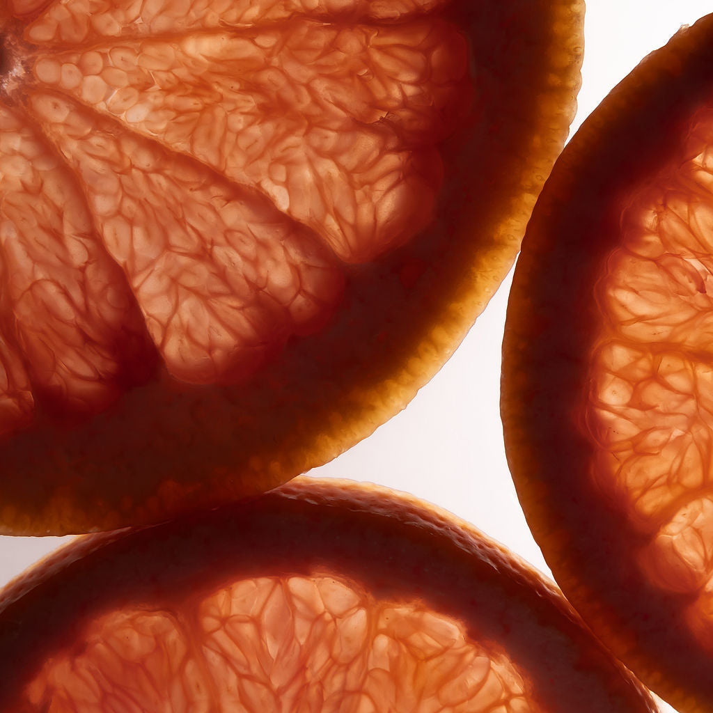 Close-up of sliced grapefruits with a white background