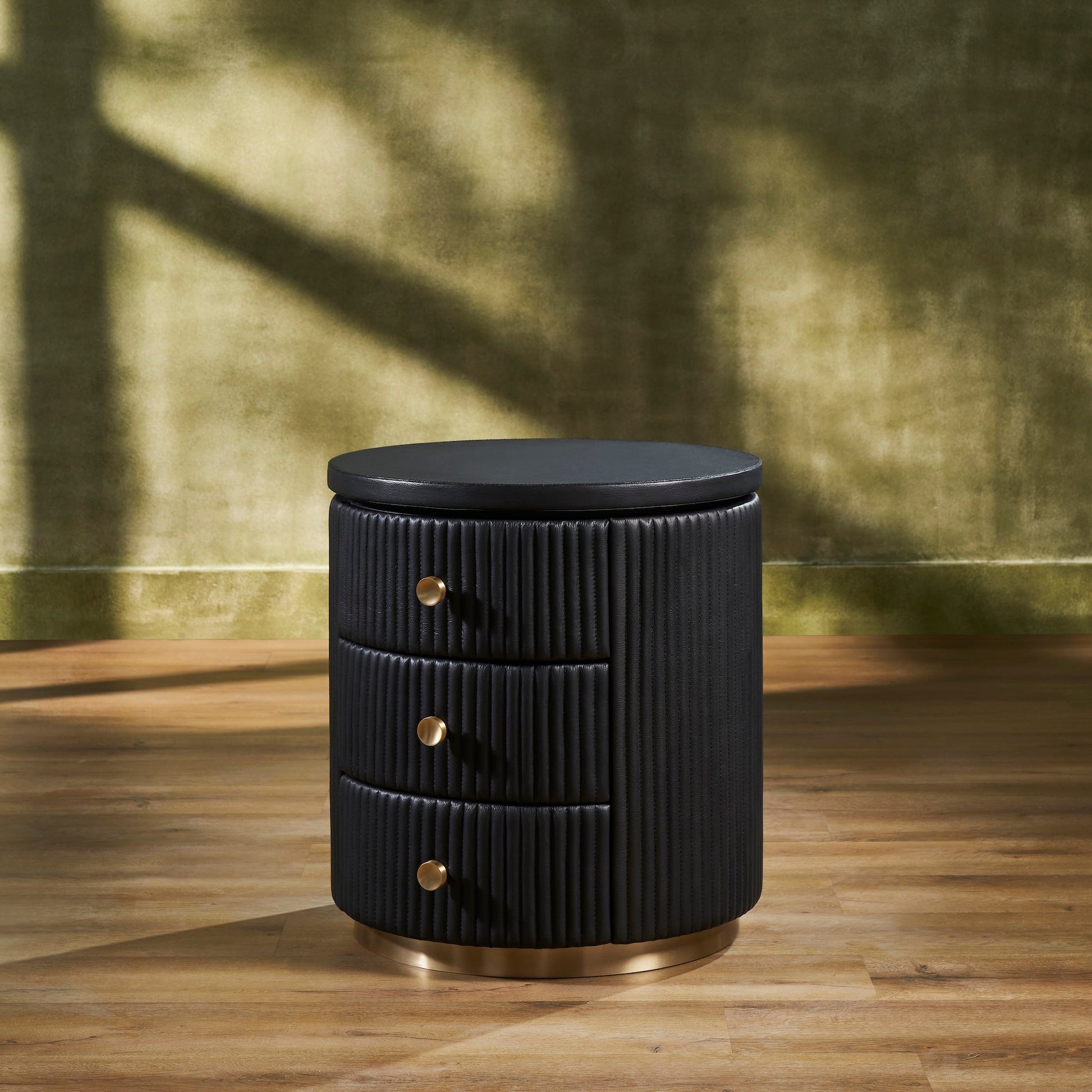 FN-5213-202022_2|Elegant black fluted leather round nightstand with three brass pull drawers, perfect luxury leather bedroom furniture.