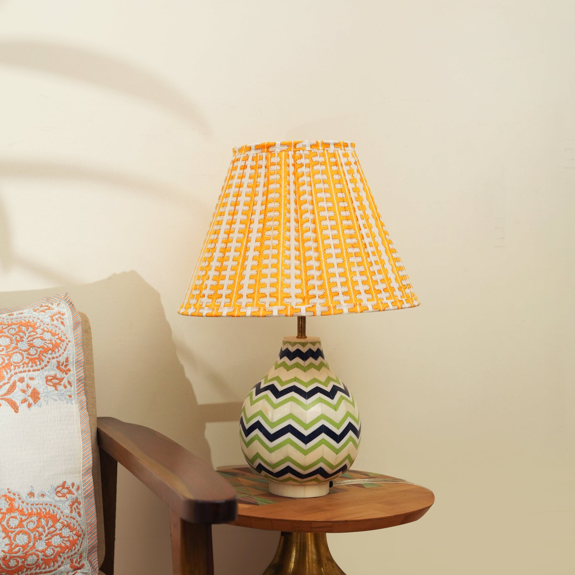  Vibrant blue and green chevron lamp base providing a pop of color on a modern writing desk.
