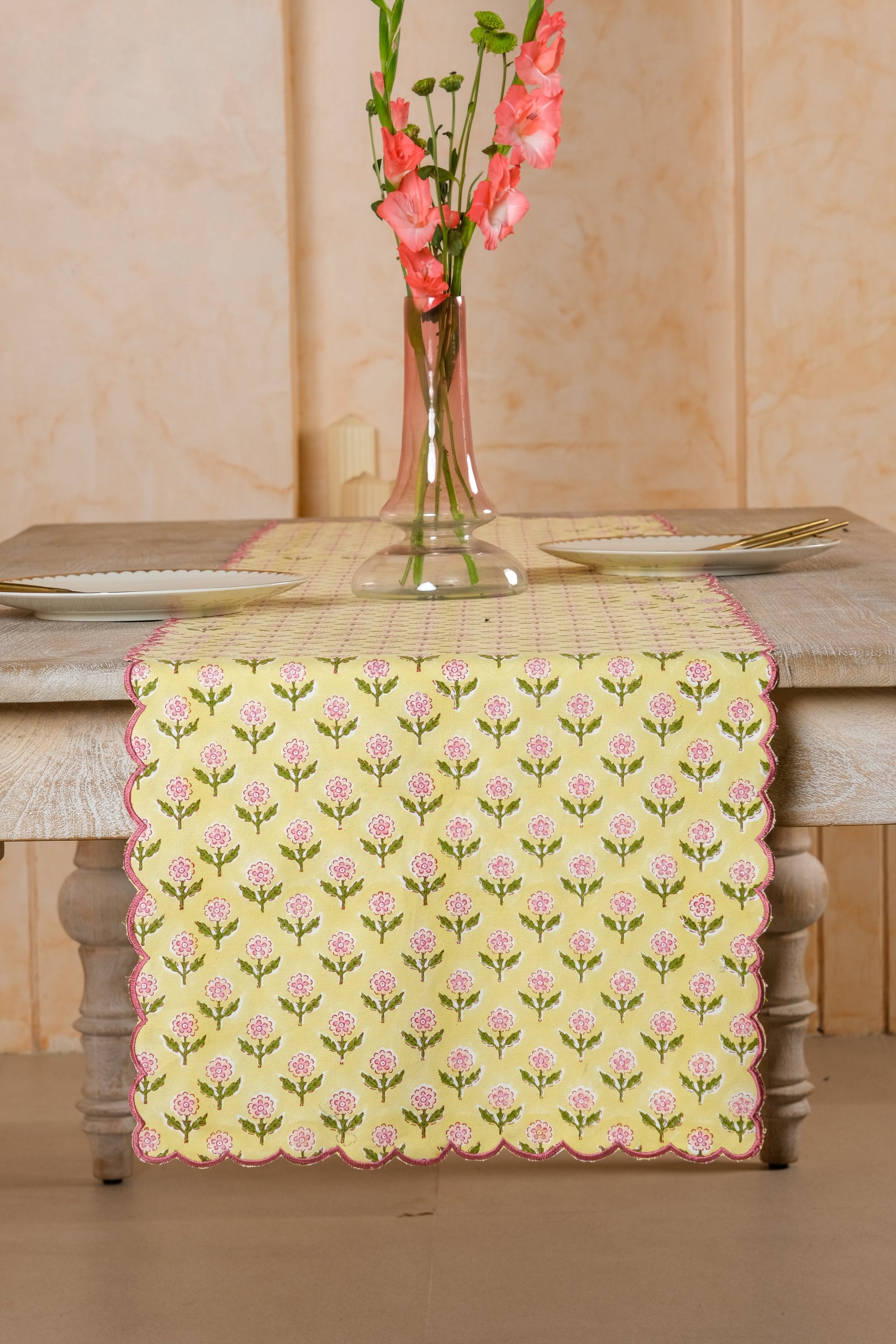 Mona Scallop Embroidered Blockprint Tablerunner in Butter Yellow on rustic wooden table