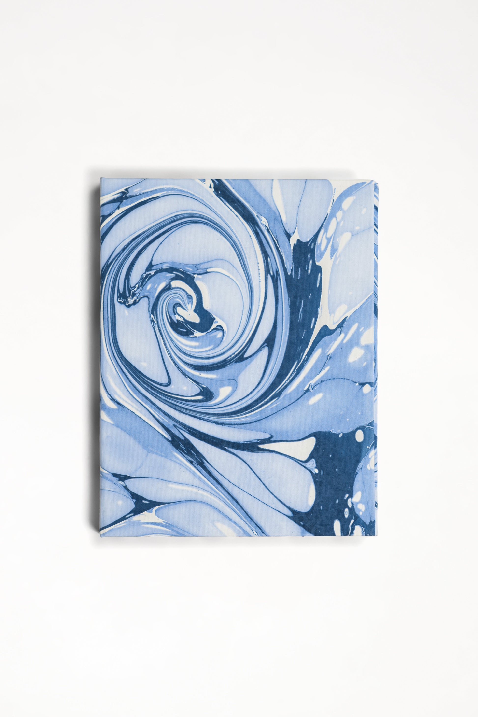Close-up of hand-marbled ocean wave pattern on folding book frame