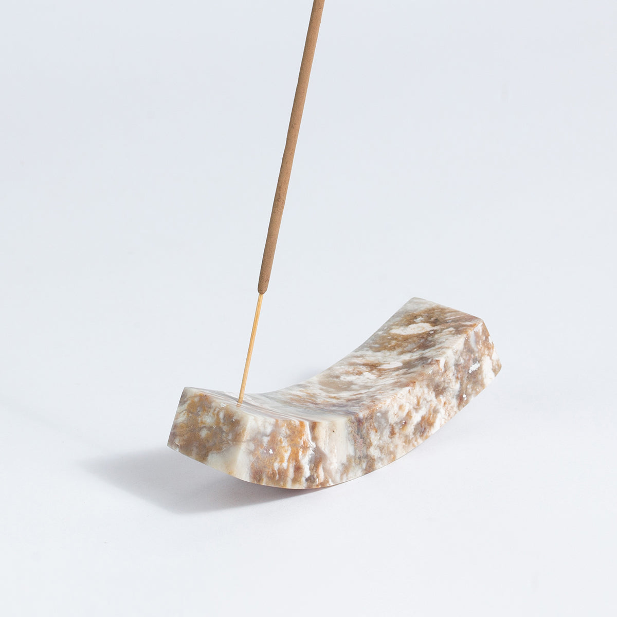 Close-up view of the handcrafted creamy soapstone incense holder showcasing its smooth, matte finish on a white background.