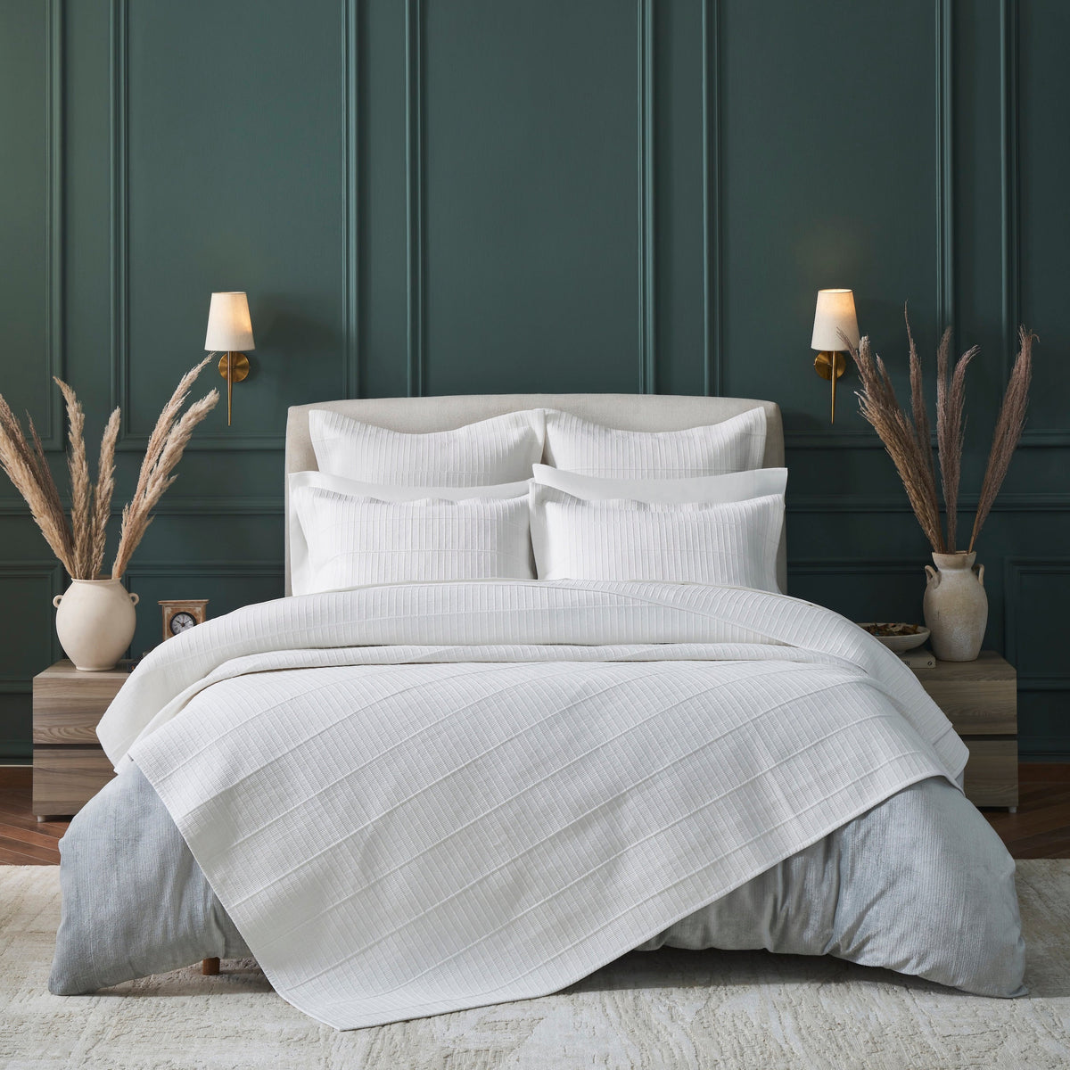 CL-268-9496_1|Elegant white textured coverlet styled in a modern bedroom with matching pillow shams, creating a cozy and sophisticated ambiance.