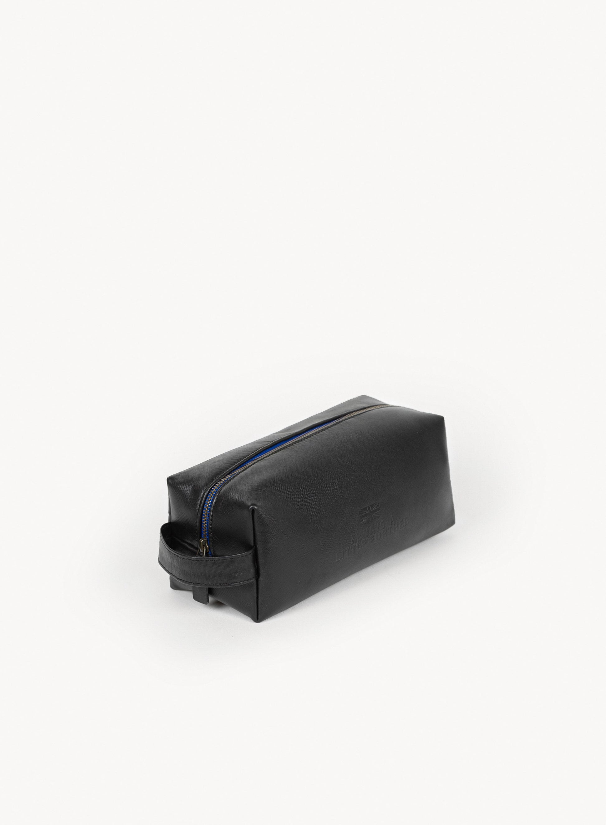 iron tight toiletry bag in black showcasing blue stitching and handle side-view.