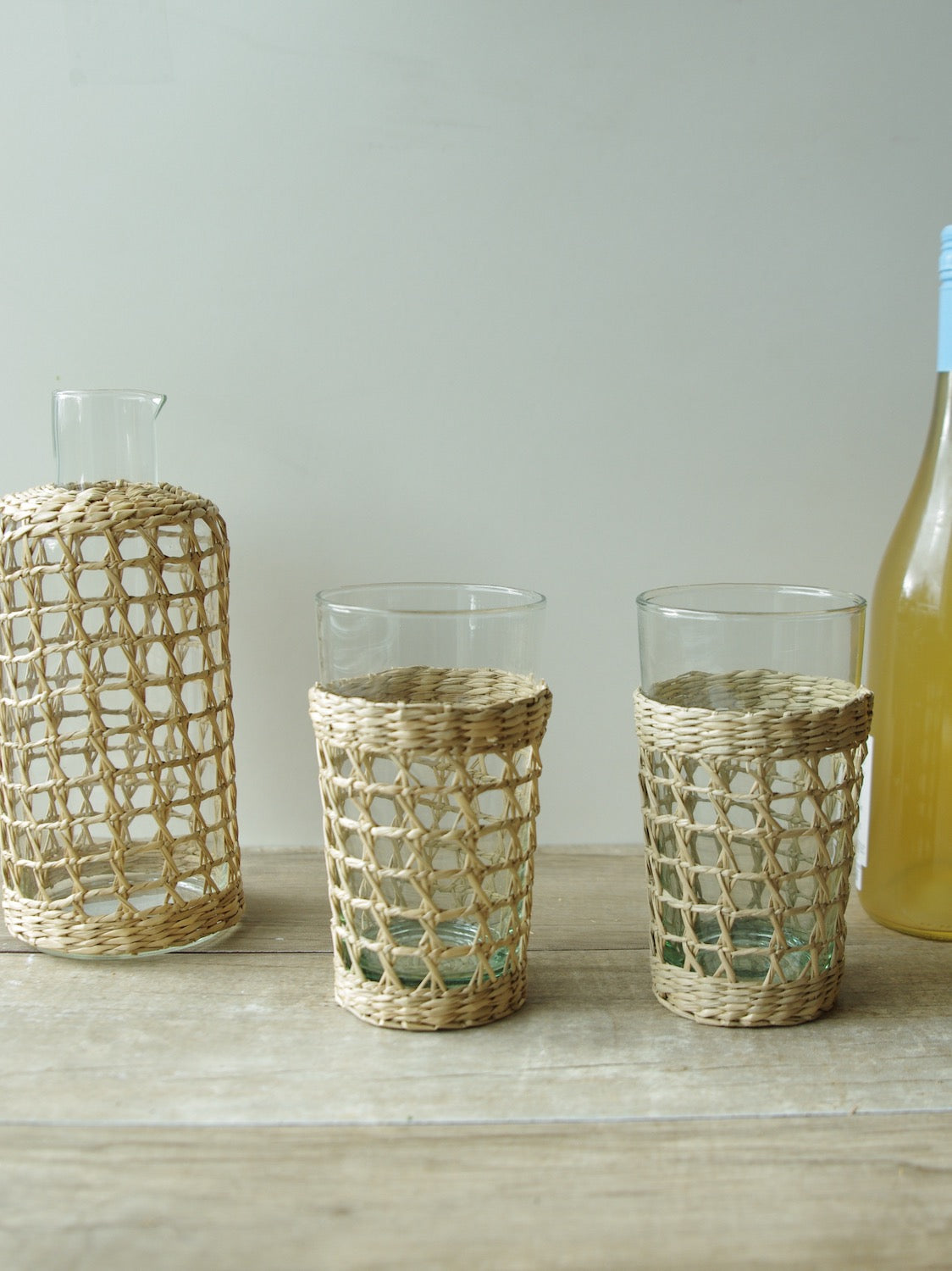 Seagrass Large Cage Carafe Glass Seagrass Brand_Seagrass & Rattan Carafes Kitchen_Drinkware Serving Pieces SeagrassWrappedCarafeandHighballGlasses_1124x1500_18a778b8-62dc-4653-bcba-e31036aed00f