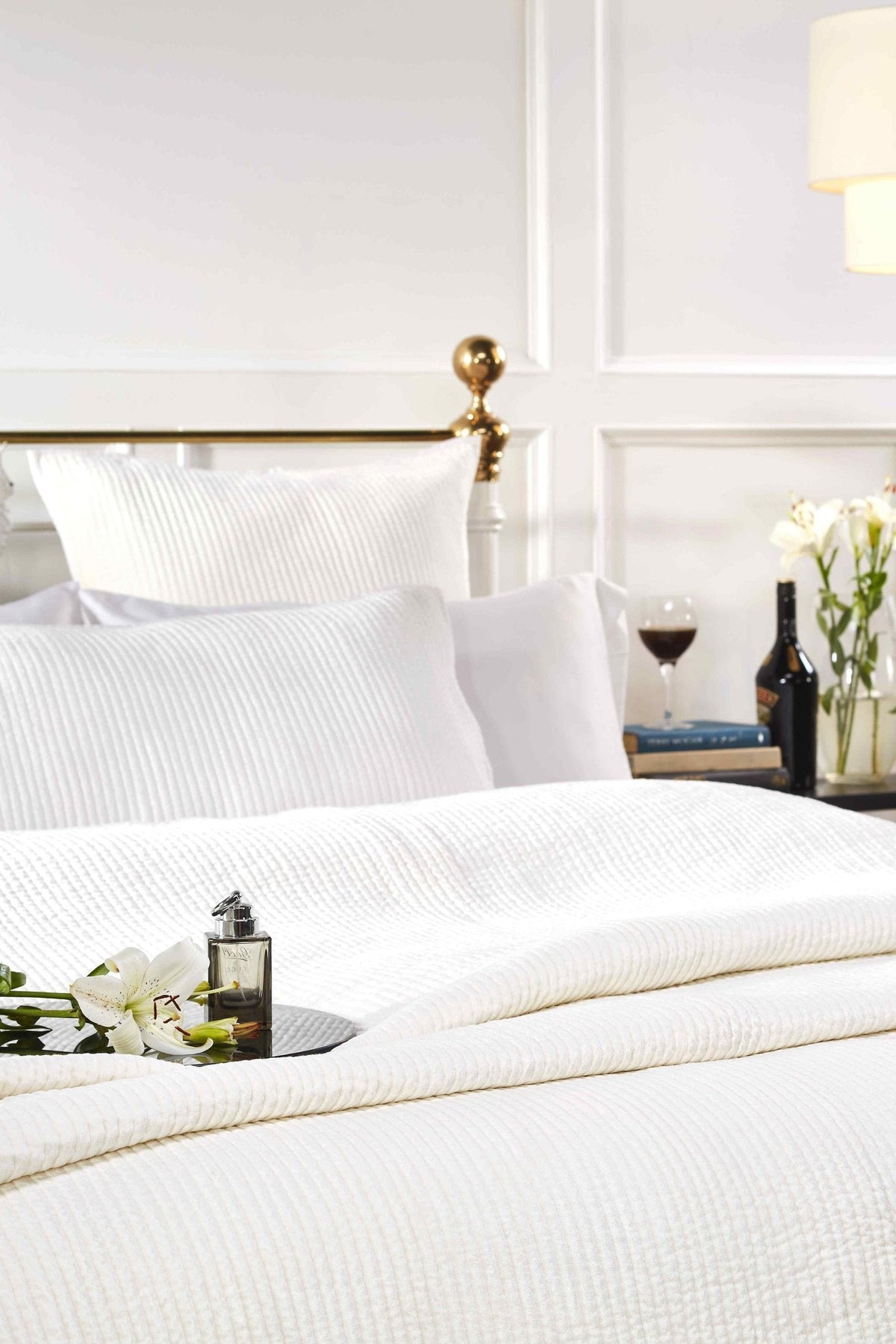 CL-157-11096_3|Pristine white textured coverlet drapes elegantly on a bed, providing a clean, luxurious, and inviting contemporary bedroom look.