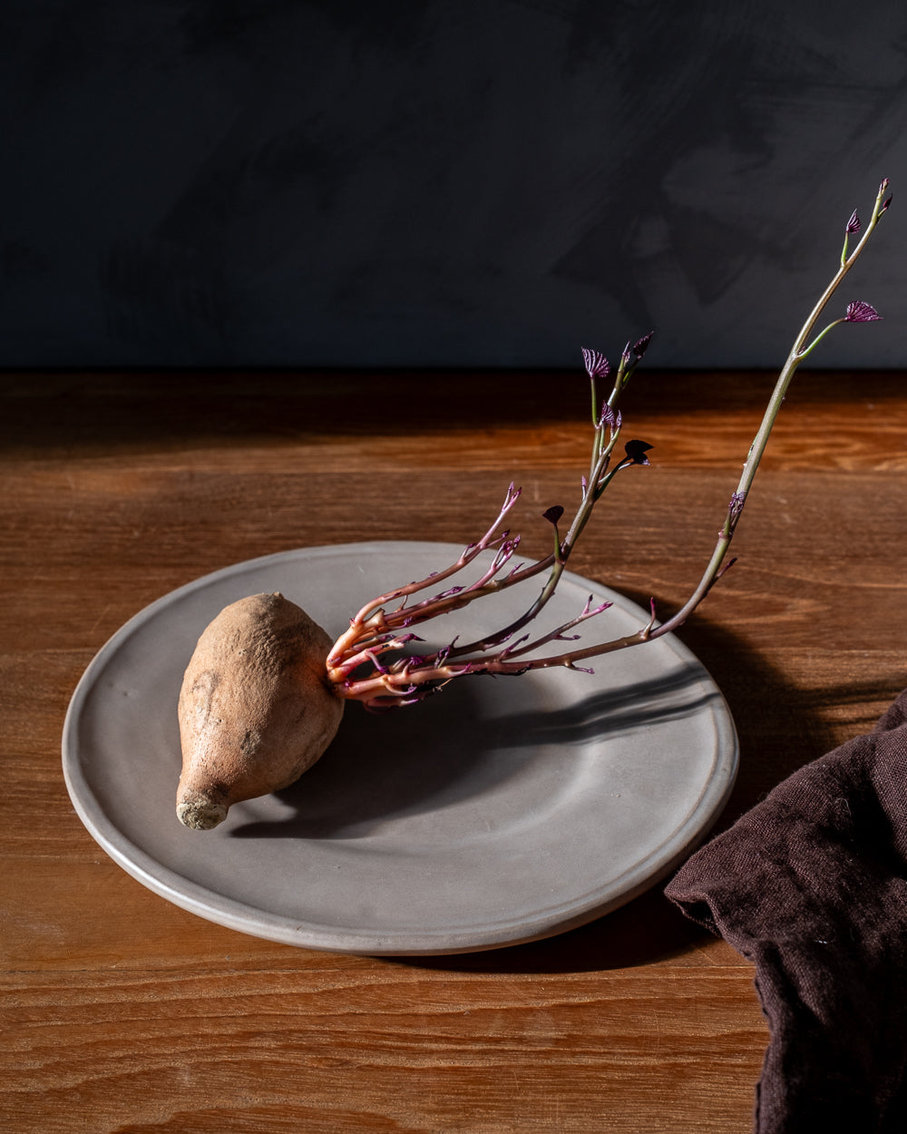 Sweet potato on a clay plate  on a wooden surface