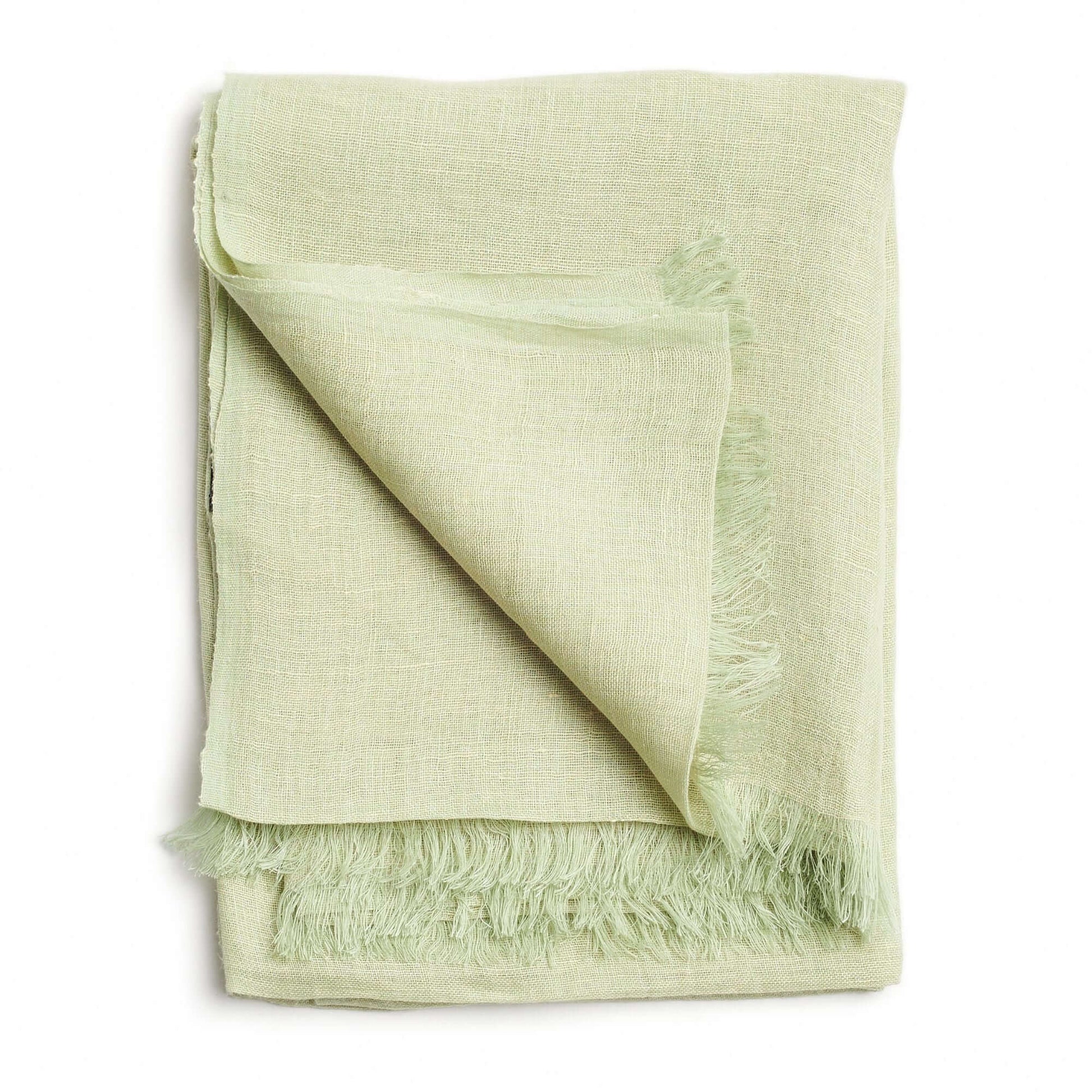 Soya Pastel Lime Green Hand Woven Soft Linen Scarf folded with fringes, showcasing its translucent texture and soft color.