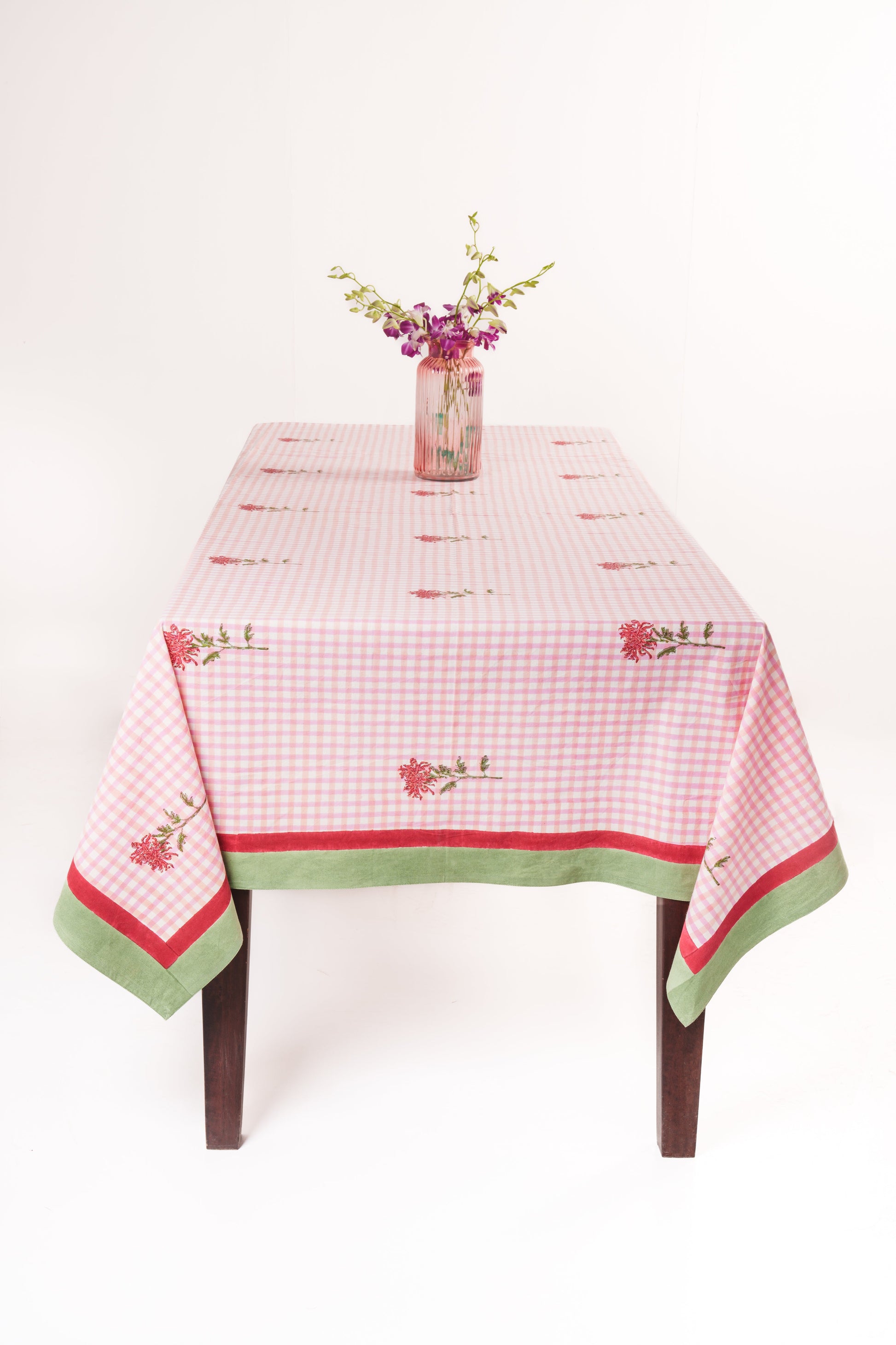 Full pink gingham tablecloth on wooden table with floral centerpiece - Inner Child