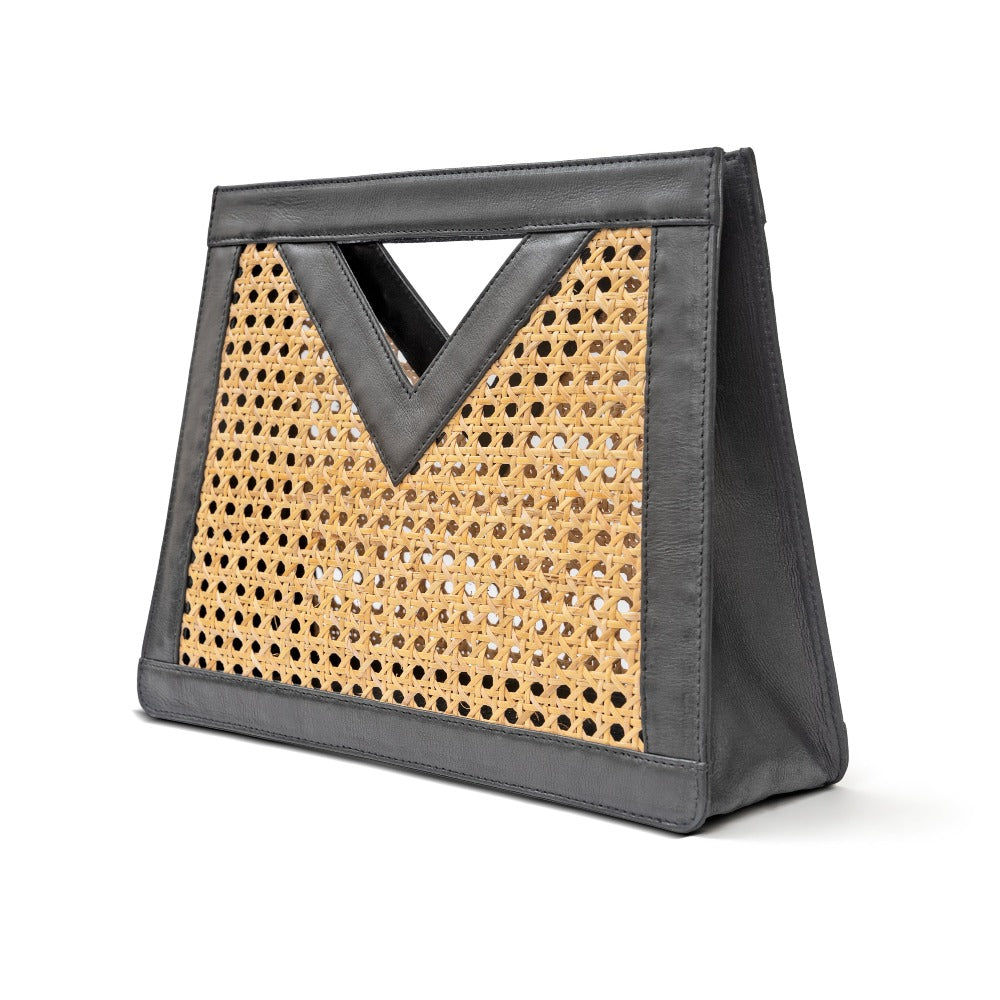 Detail view black leather and rattan cane webbing top handle handbag