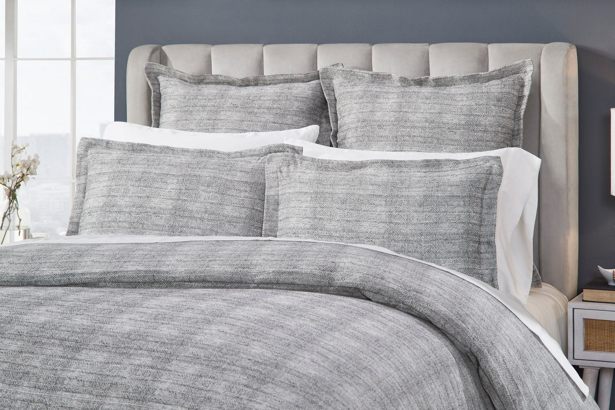 DT-034-9092_3|Close-up of a luxurious gray textured duvet cover and coordinating shams, highlighting the intricate woven pattern.