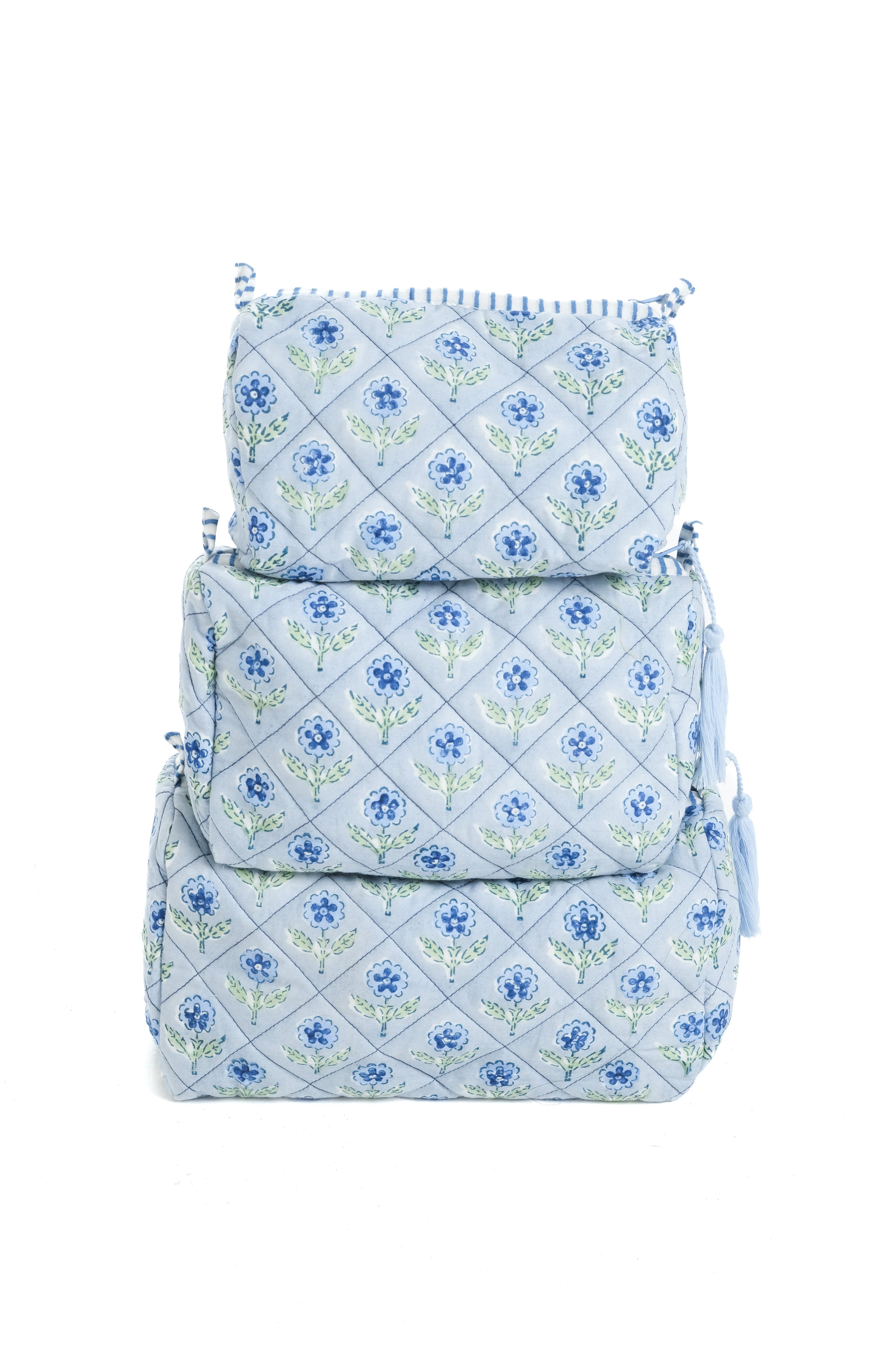 Stacked blue blockprint makeup bags with floral pattern