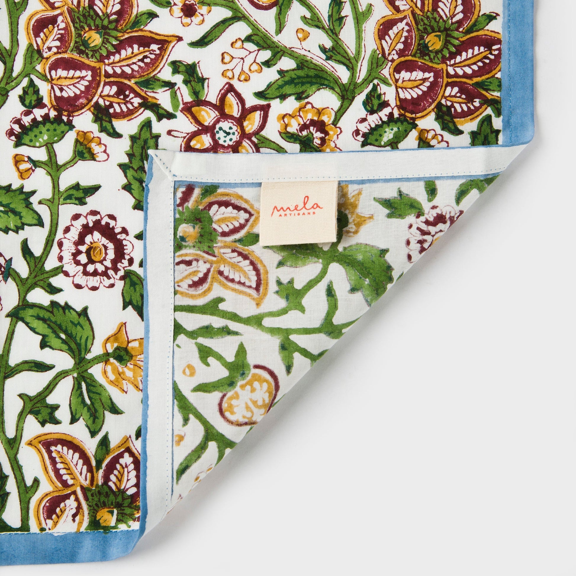 Close-up of folded Florin napkin highlighting 100% cotton texture and border.