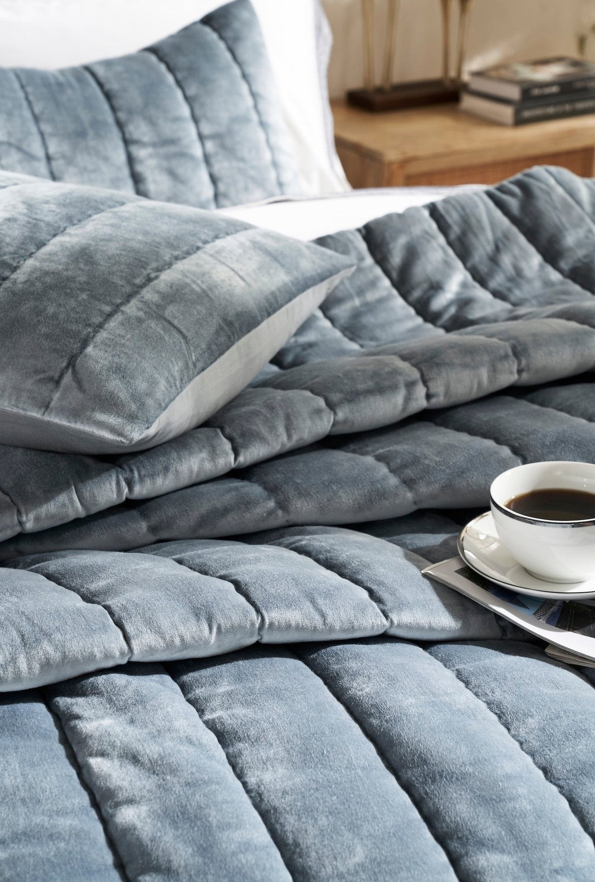 QT-360-9496_4|Close-up of luxurious velvety teal quilt and pillow, featuring elegant channel quilting design for sophisticated bedroom comfort.