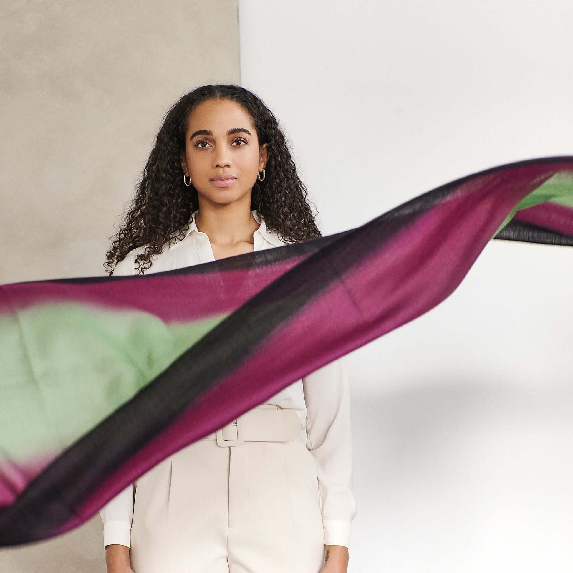Iris Courtyard Green Purple Hand Woven Cashmere Merino Scarf displayed by model with flowing design.