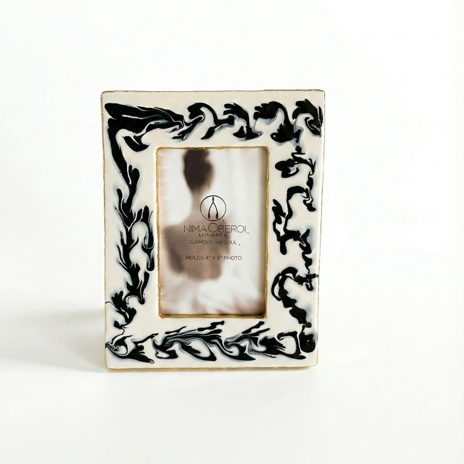 Decorative picture frame with black floral patterns on a white background