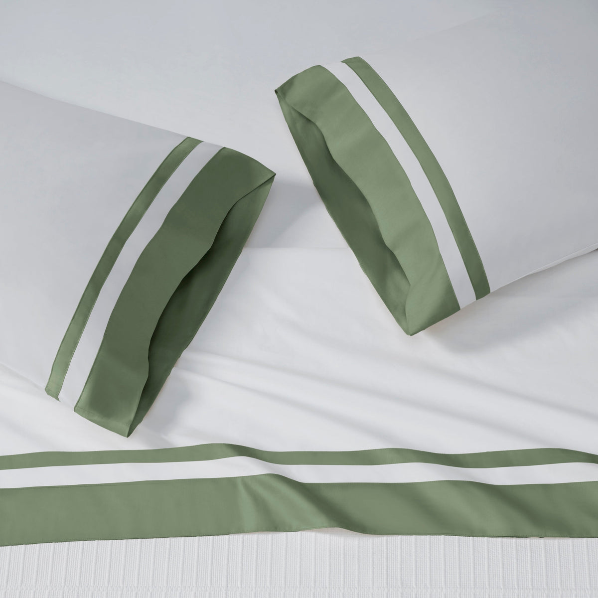 AKP-542-2040_2|White 100% cotton sateen sheet set with two pillowcases and a flat sheet, each featuring wide olive green and white striped borders.