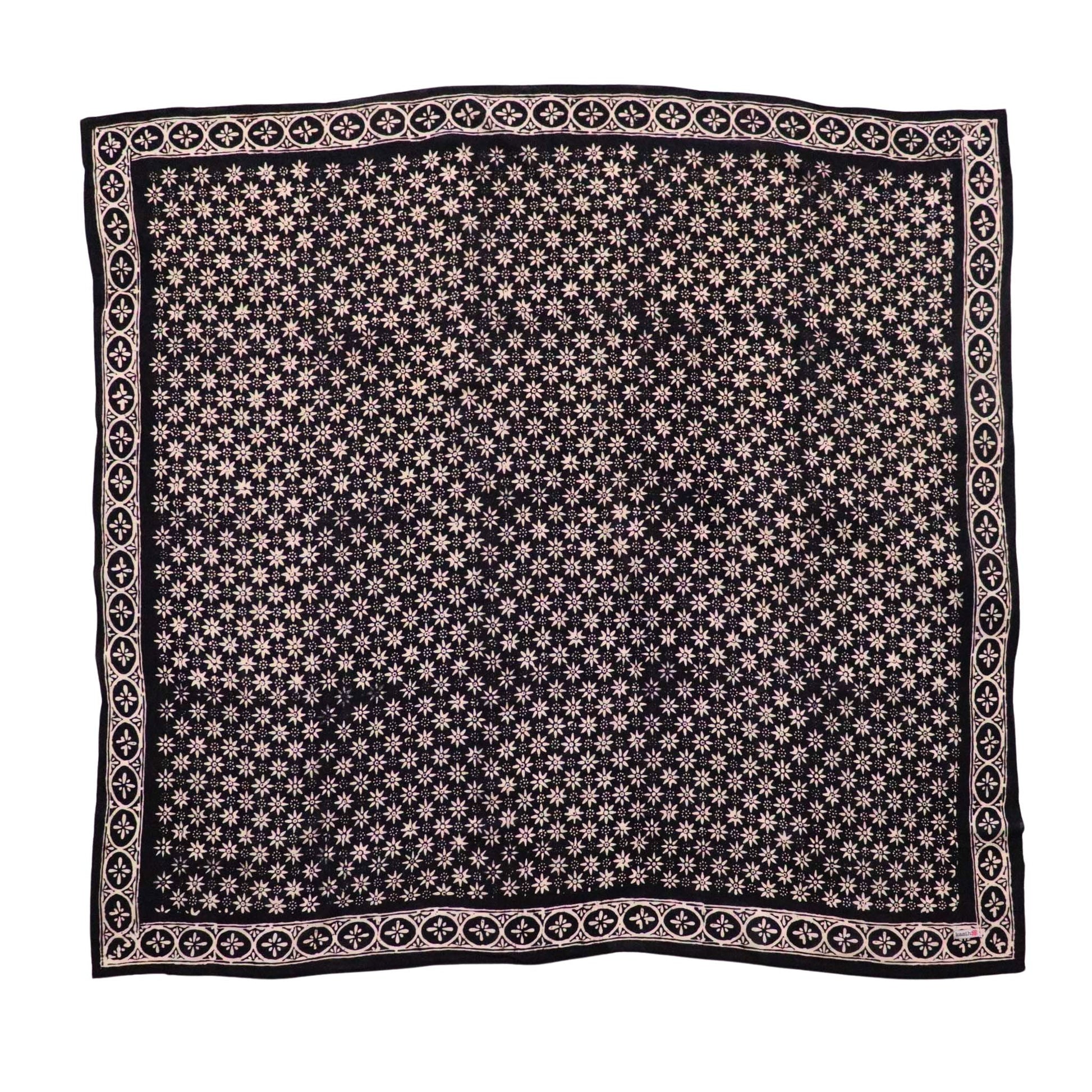 A black and gray hand-dyed batik bandana with a geometric pattern.